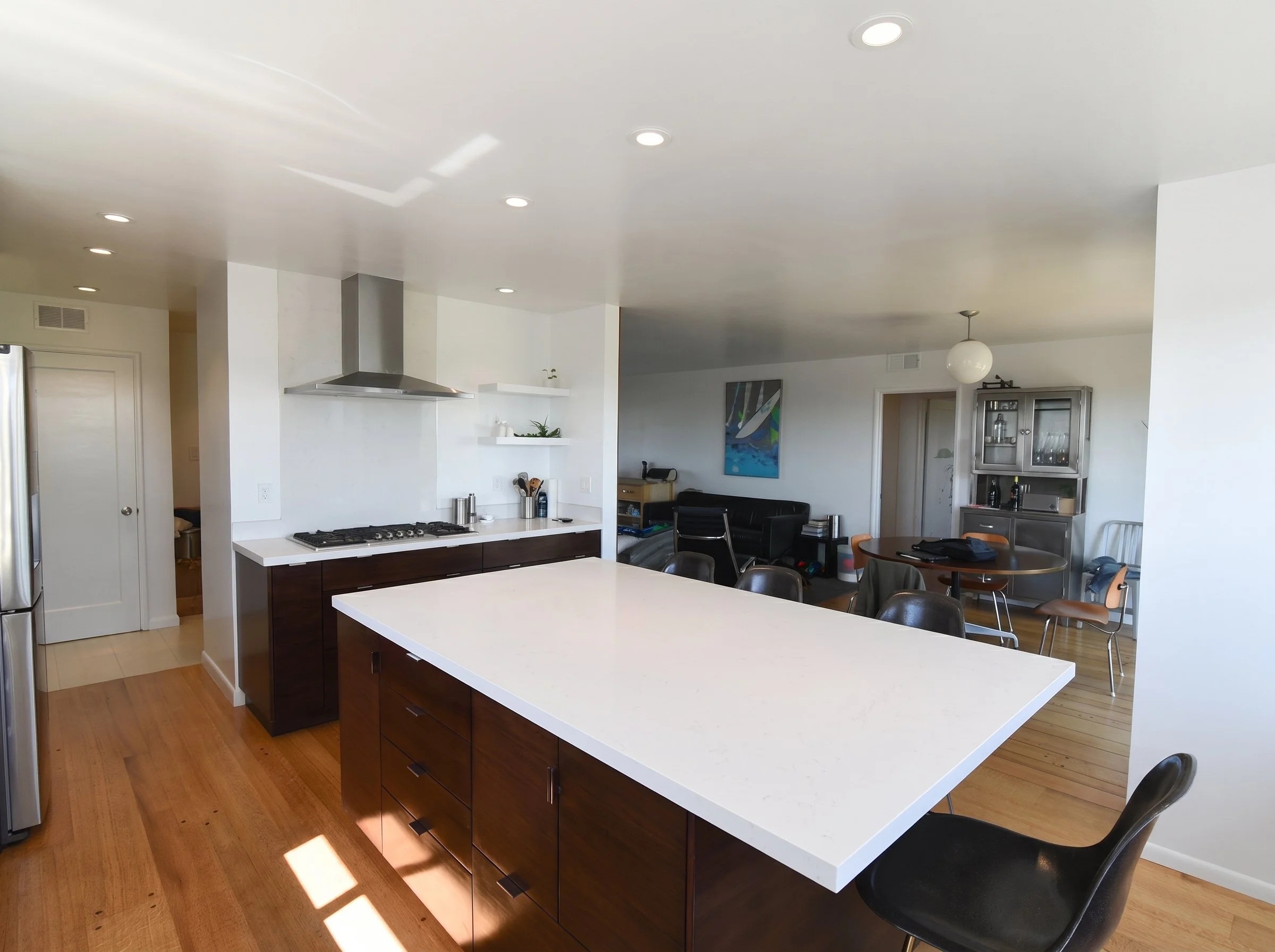 Island and ceiling-hung hood, open to the dining area.