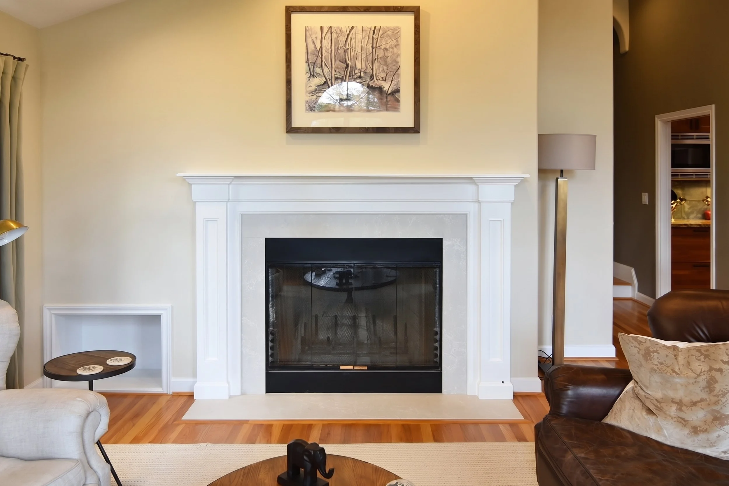 Living room fireplace with a white mantel.