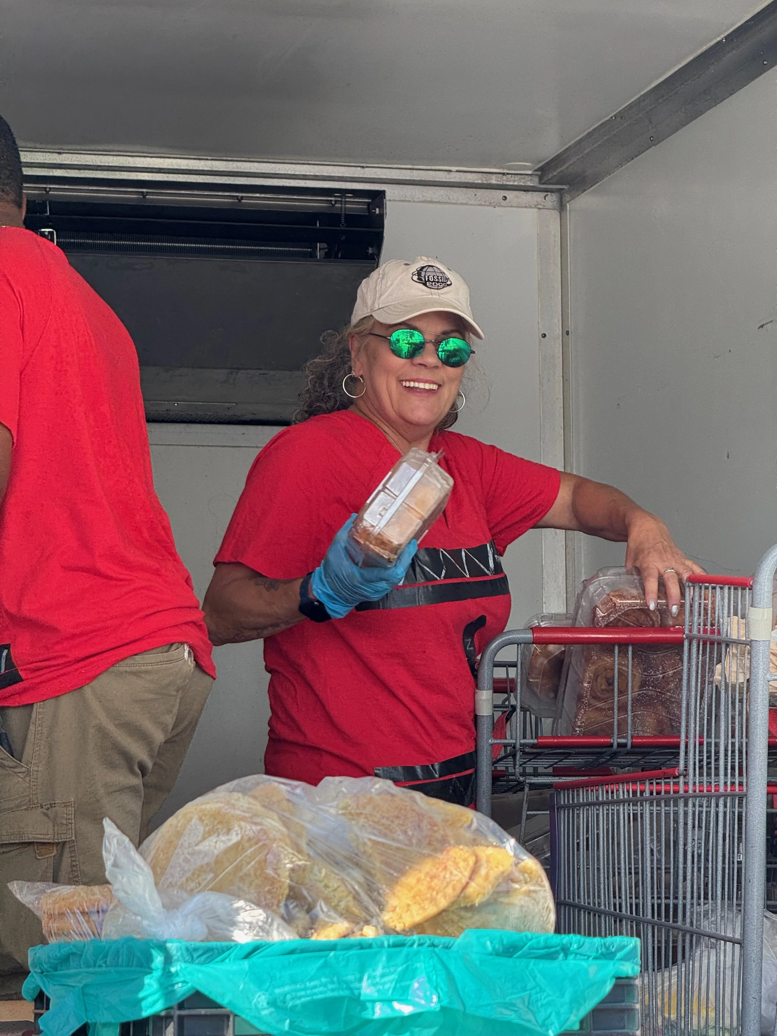 Donna, our Founder & CEO, wearing a smile on the back of the refrigerated truck.