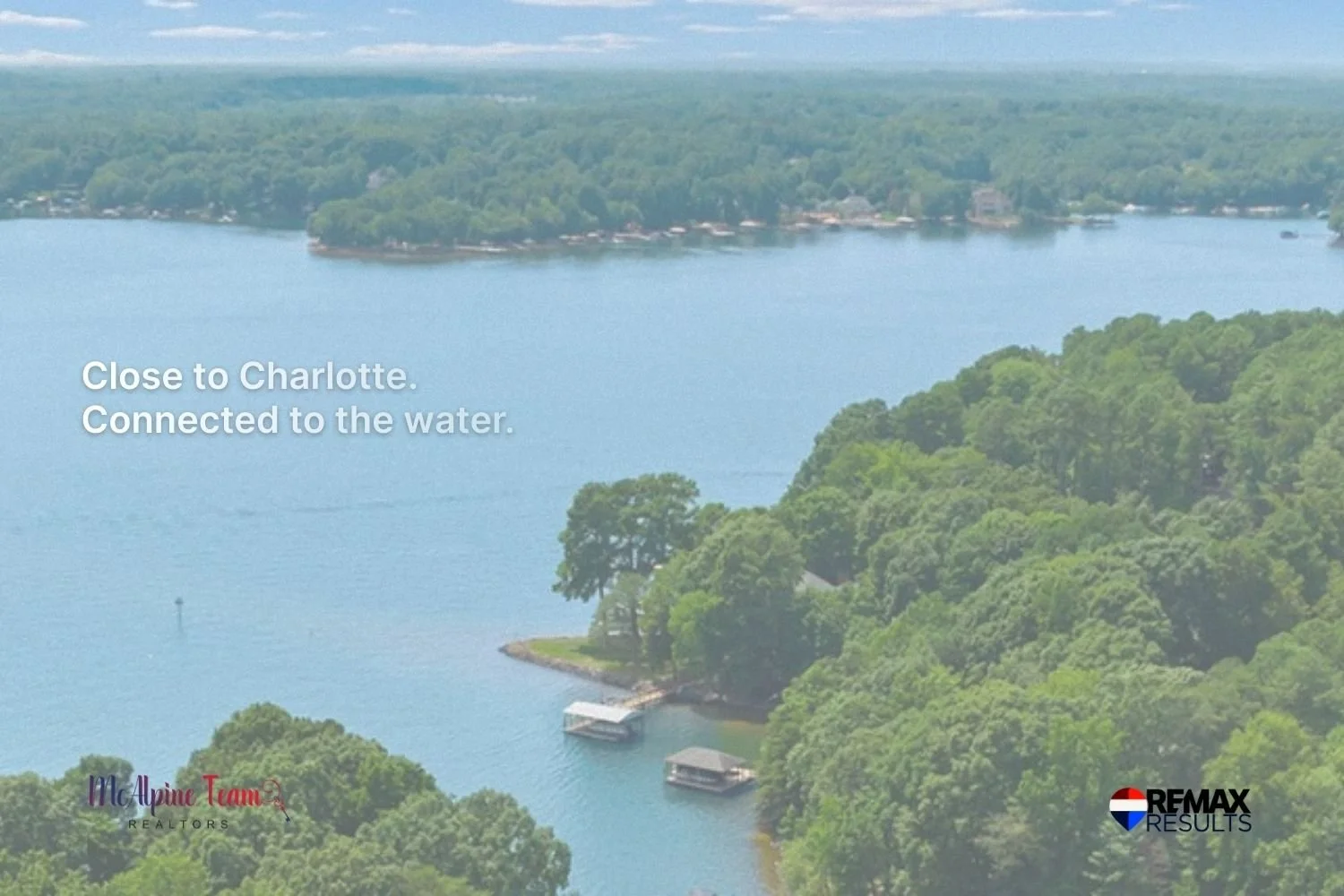 Aerial view of a wooded Lake Norman cove with docks highlighting proximity to Charlotte and waterfront living