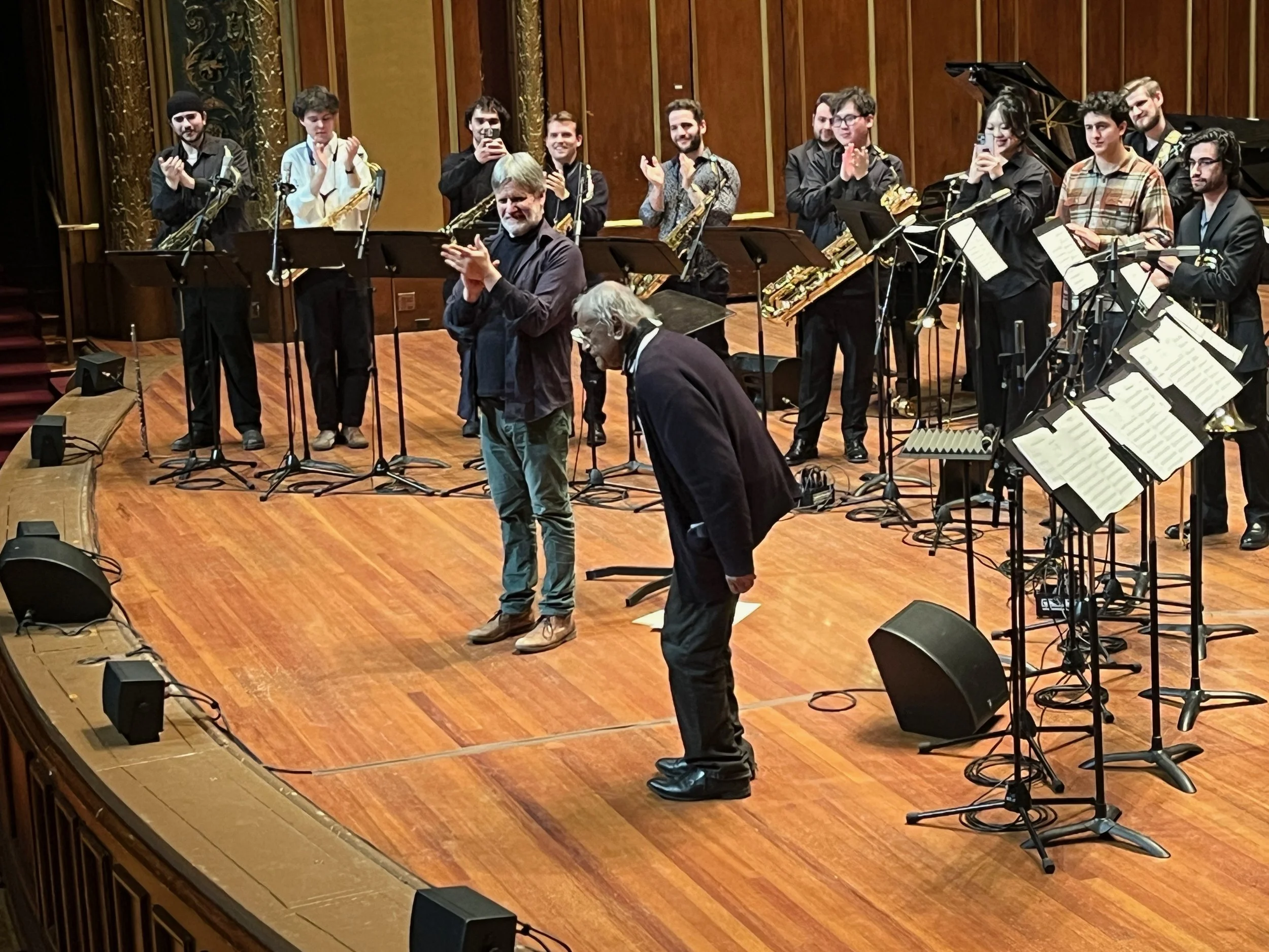 Braxton bows in front of Frank Carlberg and the big band
