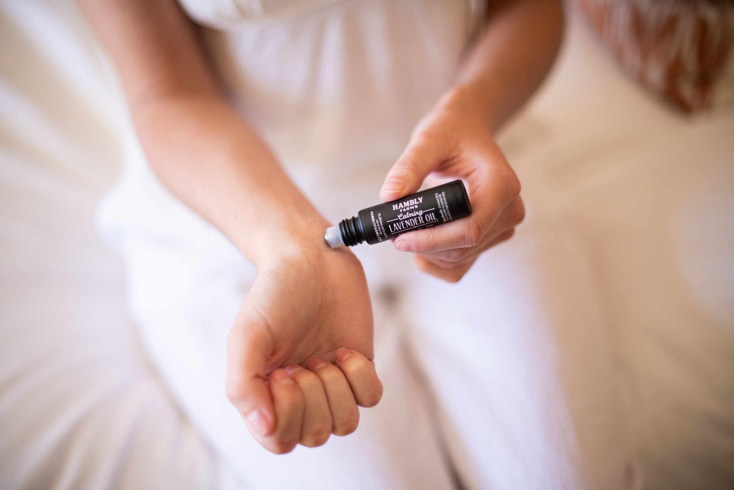 Hambly-Farms-Calming-Lavender-Oil-Roller-Lifestyle-applying-to-wrist