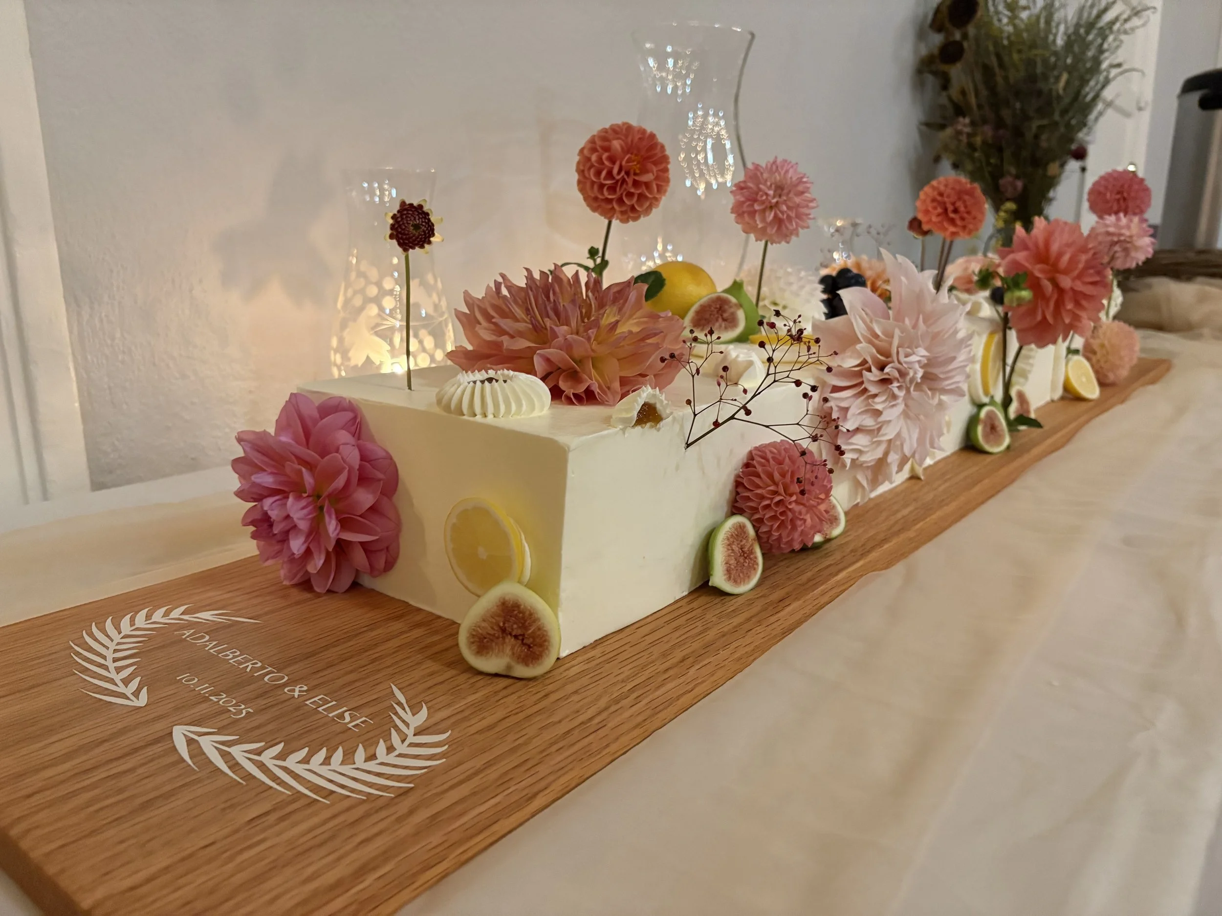 Long cake. seasonal florals. fresh fruit. whimsical piping. 