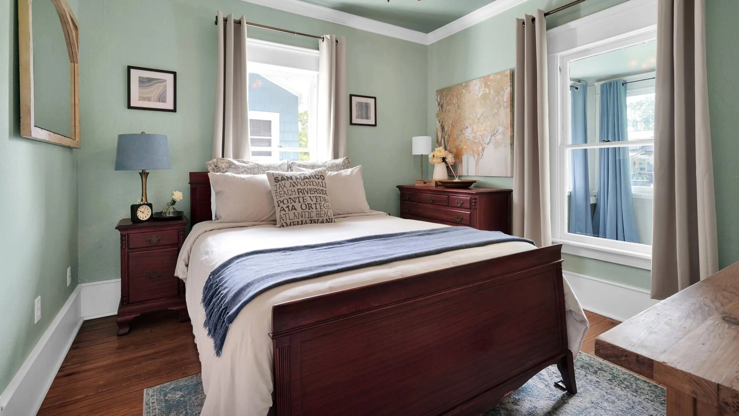 Calm, thoughtfully styled bedroom with layered bedding and warm lighting designed to enhance guest comfort and improve vacation rental reviews.