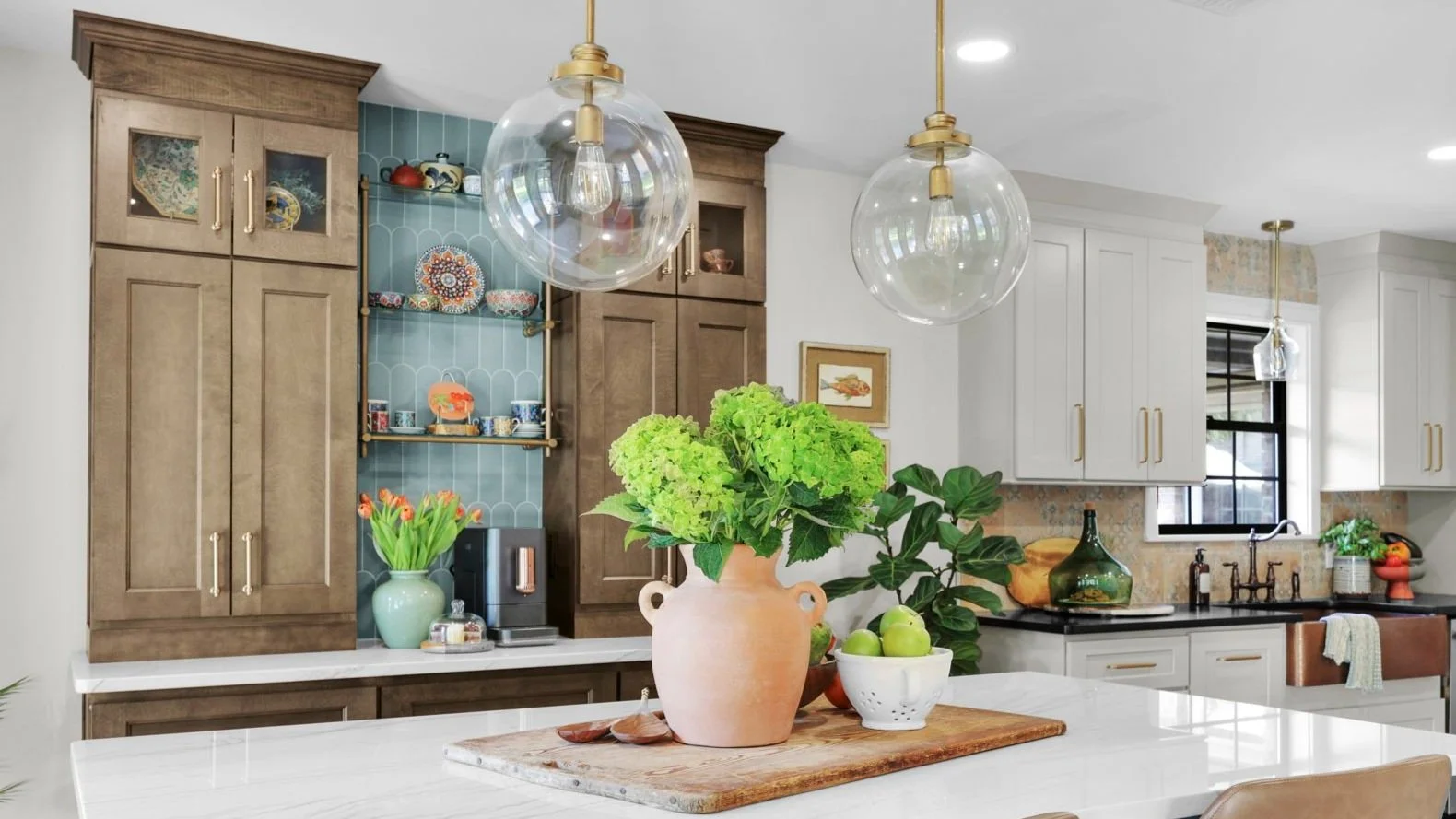 Transitional kitchen with coffee bar, travel dishware and accessoires adorn the glas shelving above the coffee station.