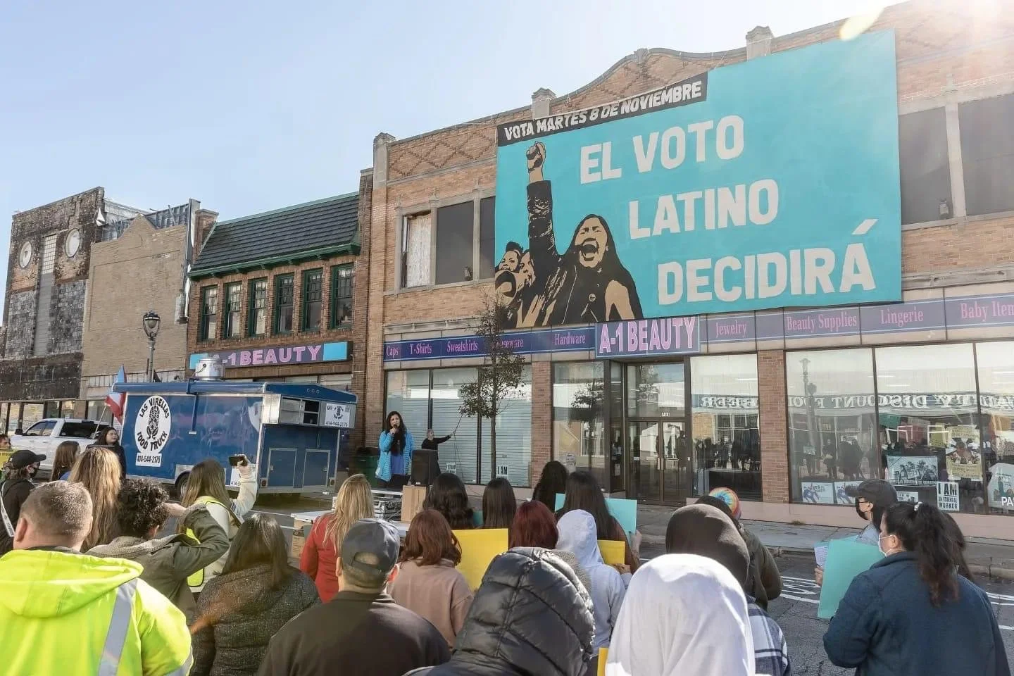 Voces de la Frontera. Banner drop infront of the Mitchell Street Voces Office for a GOTV effort for the midterm elections. October 2022.