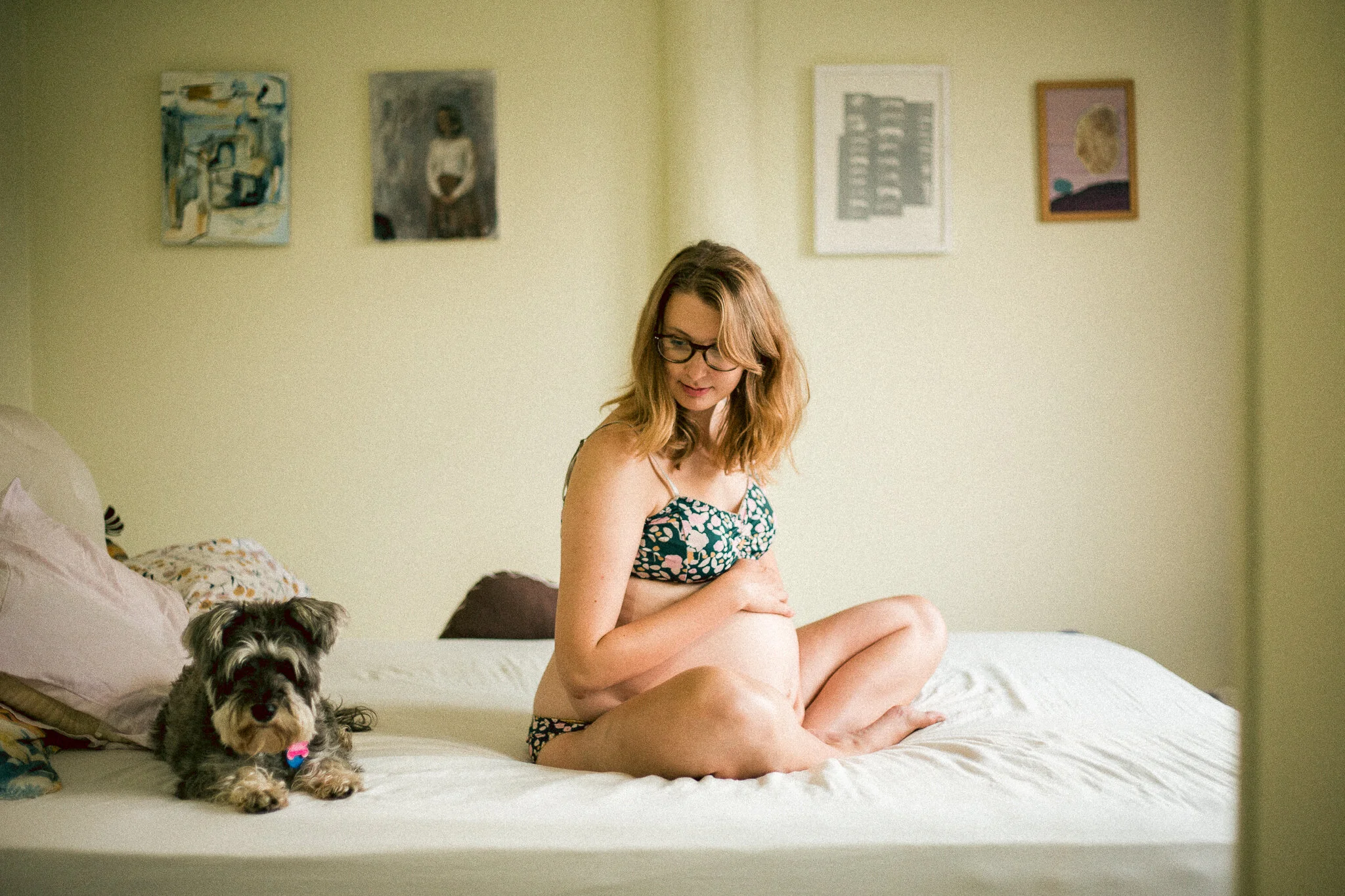 Pregnant woman sitting next to dog