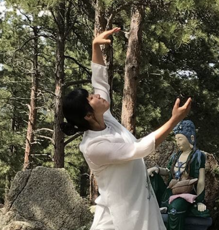 Woman practicing Tai Chi in the forest