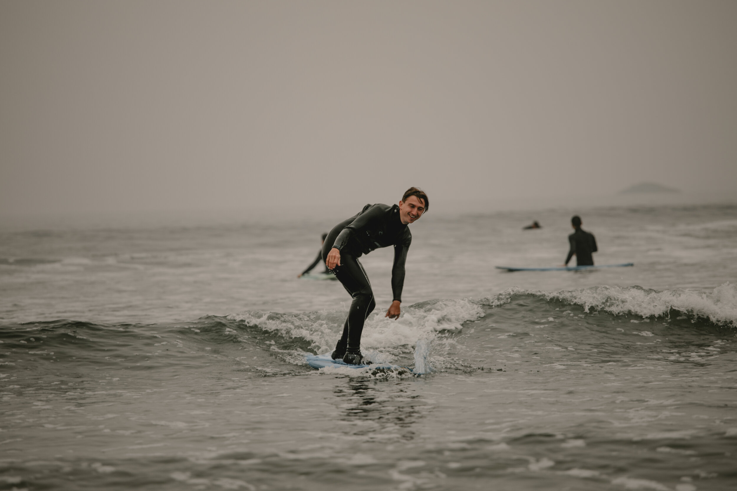 Person surfing during Long Beach Lodge Resort surf lessons