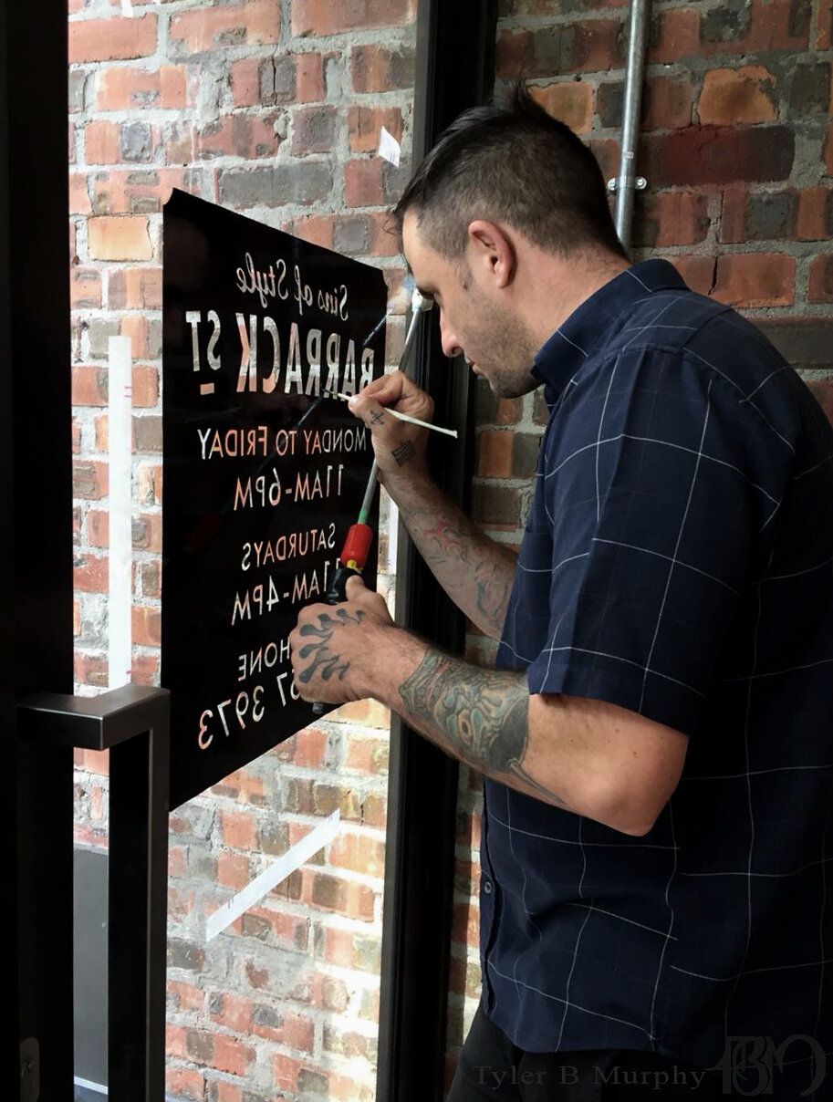 2Hand Painting a reverse glass sign before guilding it with gold leaf Tyler B Murphy  copy.jpg
