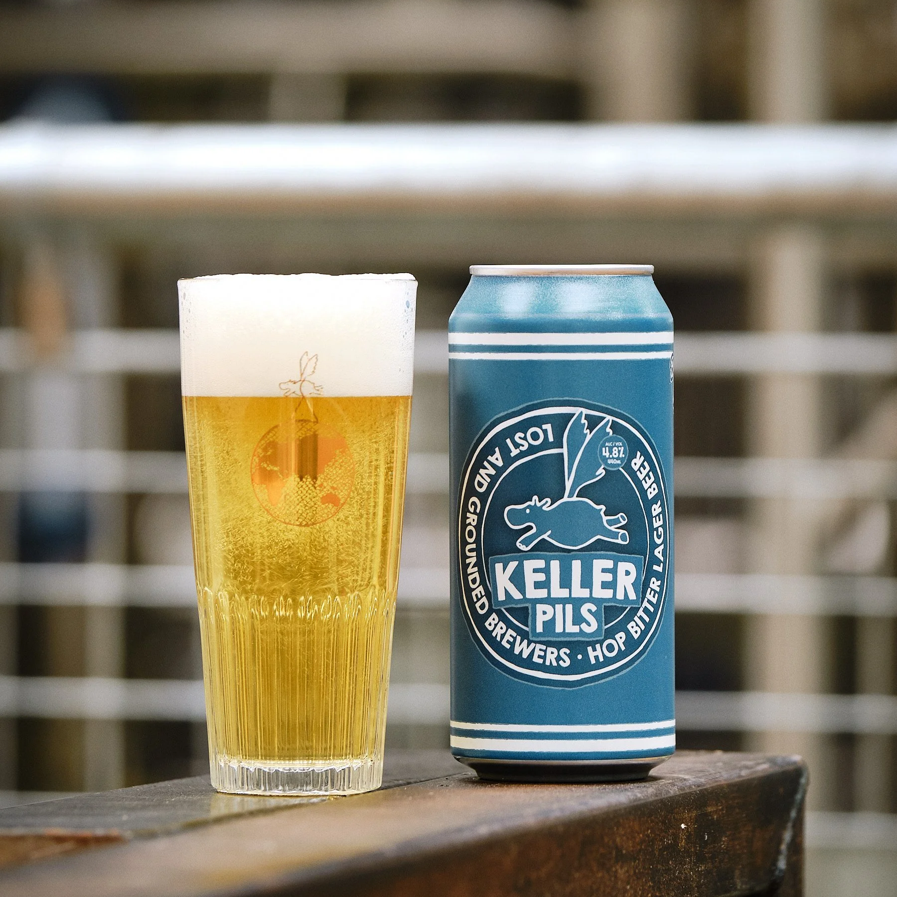 A can of Lost and Grounded Keller Pils (hop bitter lager beer 4.4%), next to a filled glass.