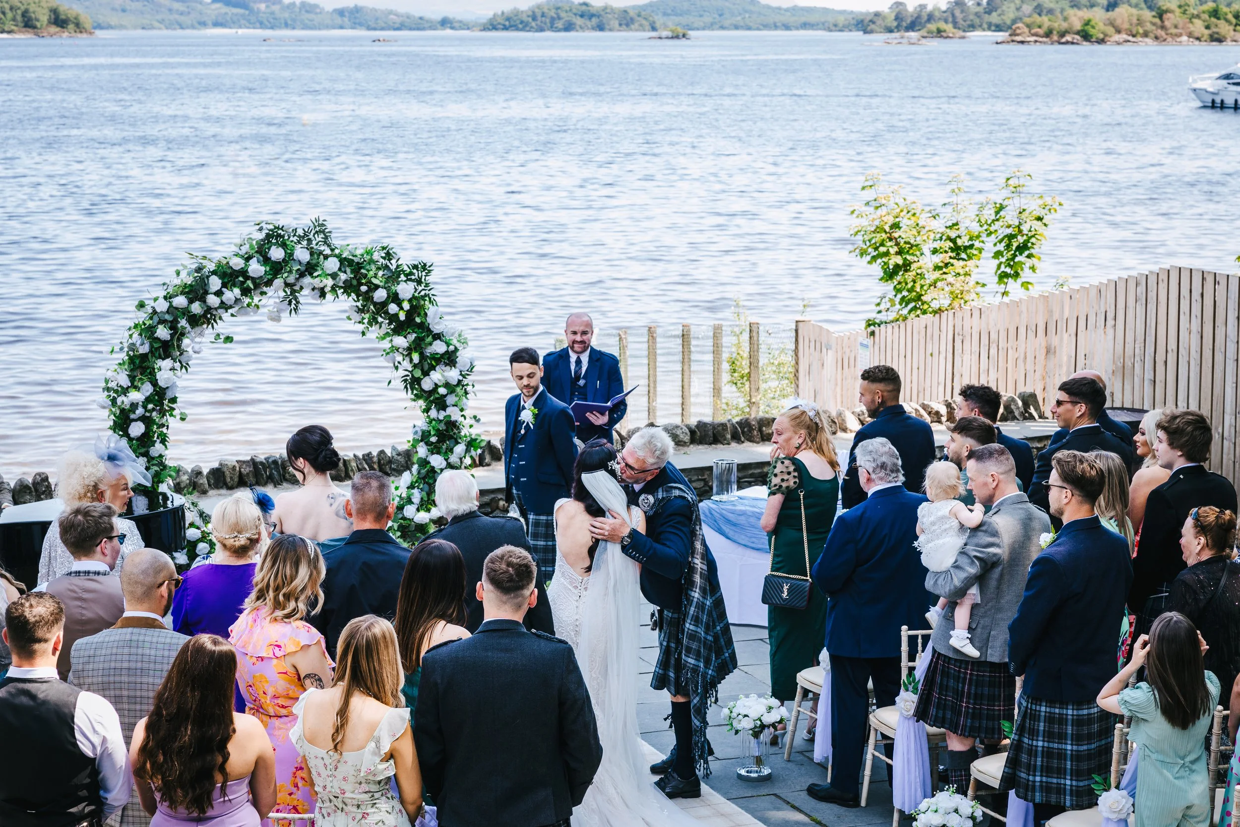 Father of the bride handoff, with a kiss and hug from dad