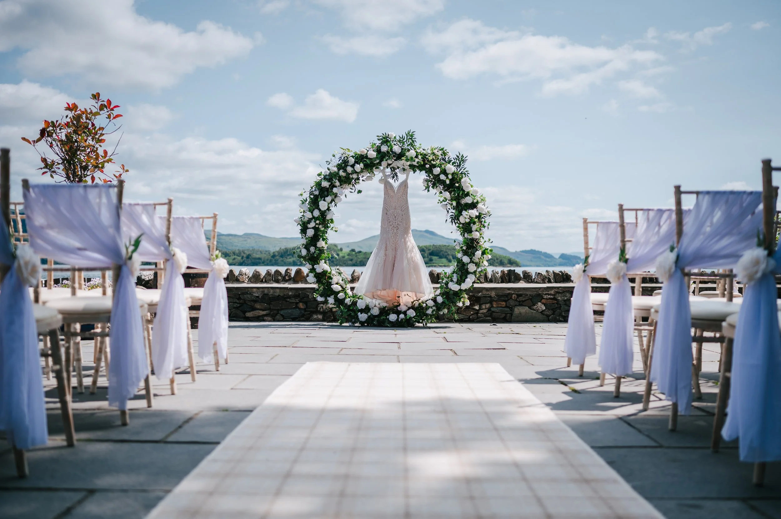 Beautiful wedding dress hanging in a Moorgate at Loch Lomond