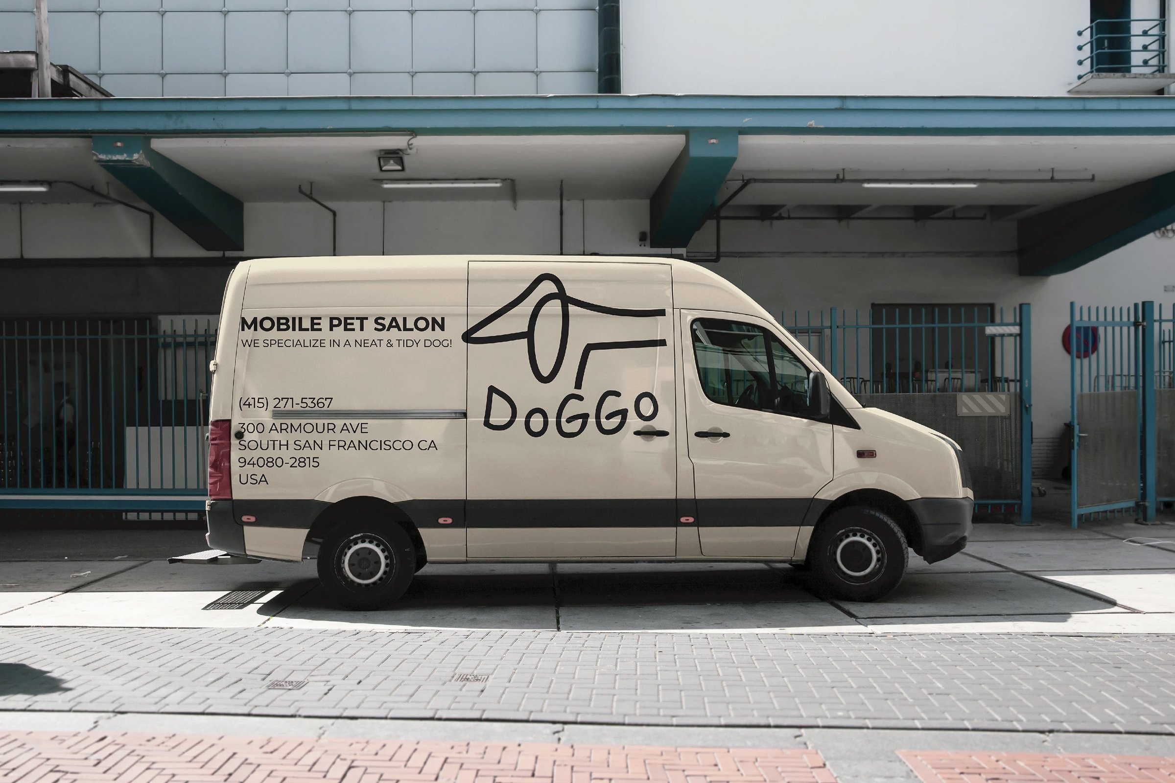 A white cargo van parked in an urban area with a logo of a dog and text that reads 'Mobile Pet Salon,' along with contact information and address.