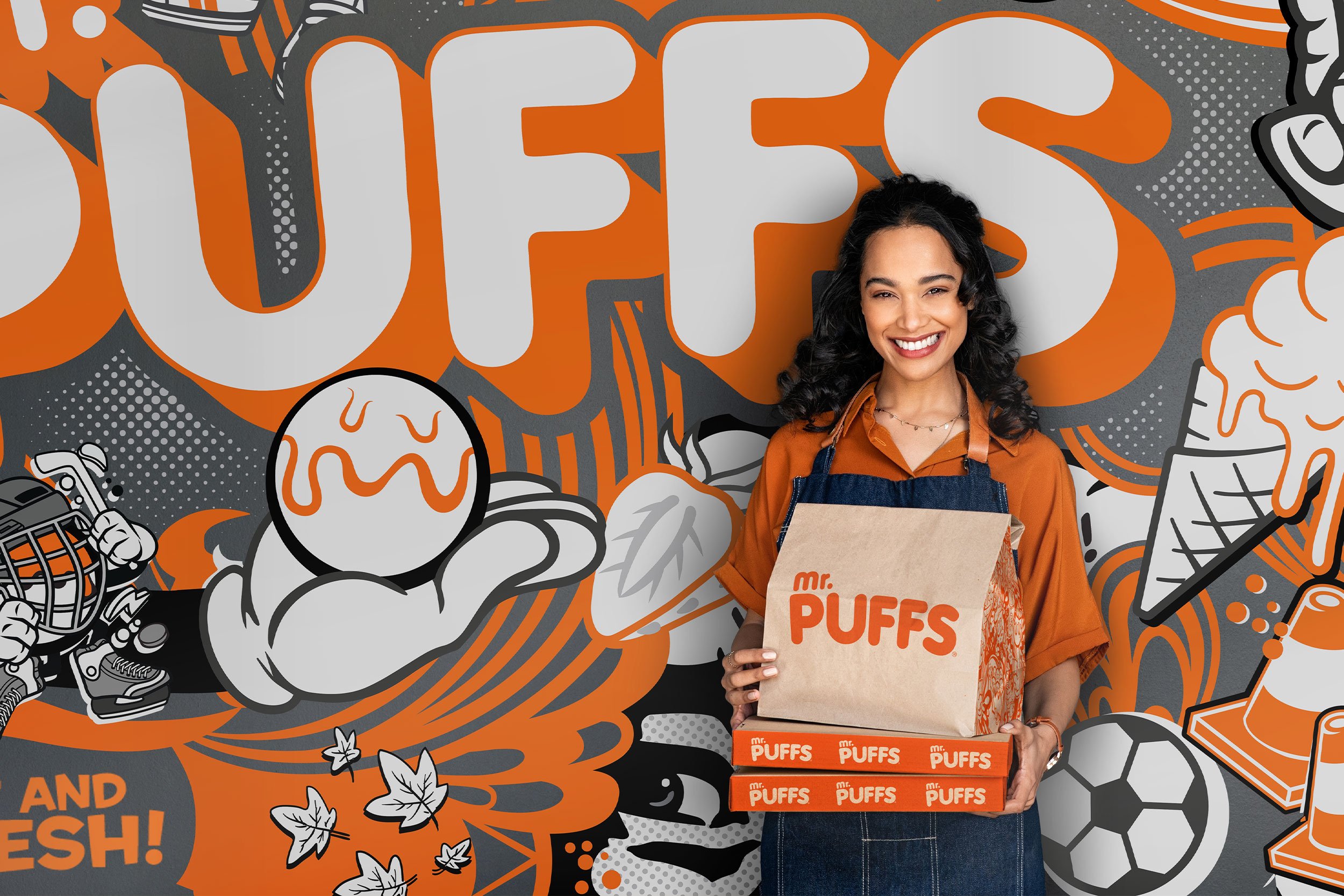 Mr. Puffs illustrated mural in orange and greyscale with customer holding a takeaway bag