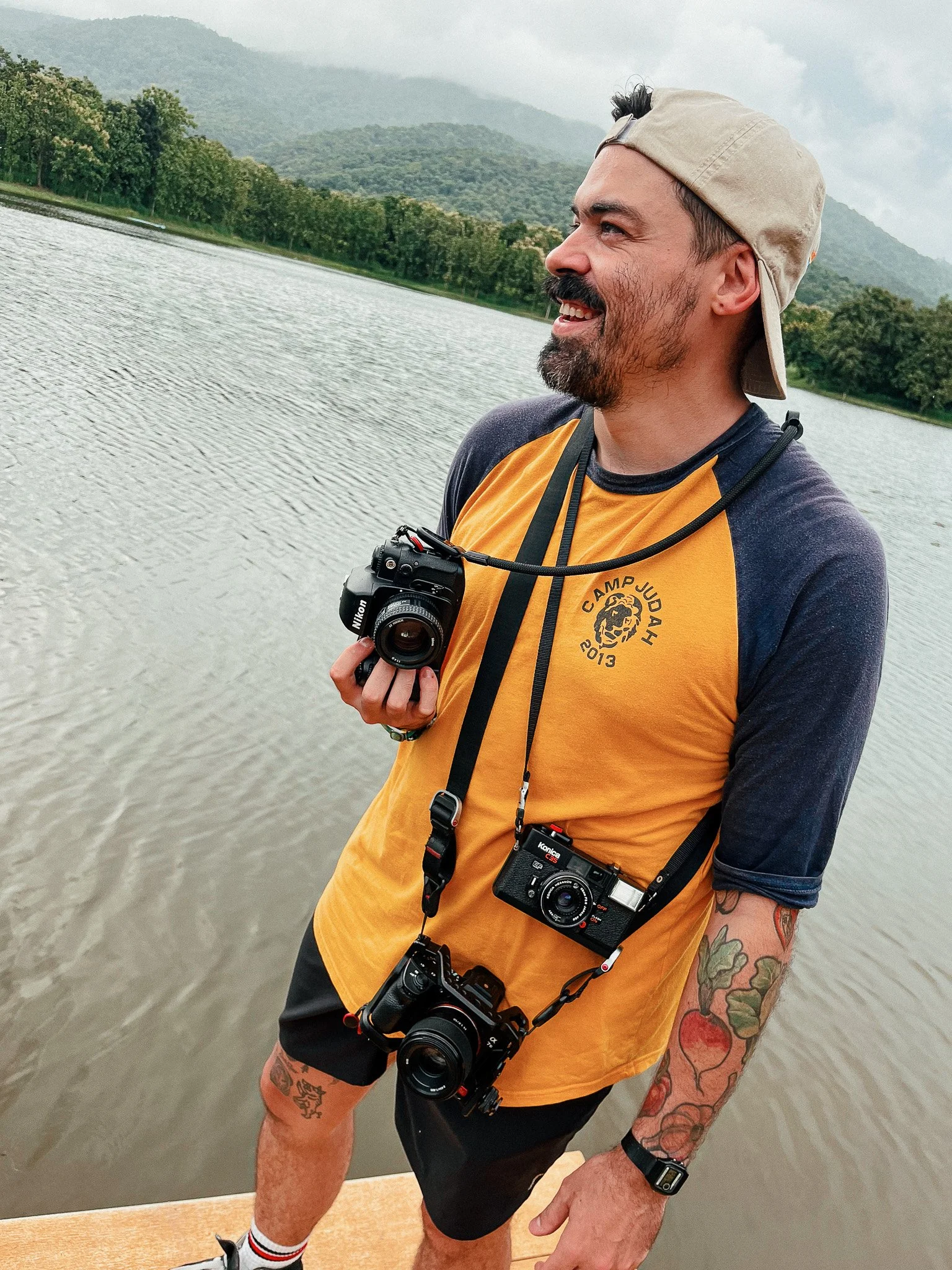 Will Langston, documentary film photographer based in Chiang Mai, Thailand, holding film cameras