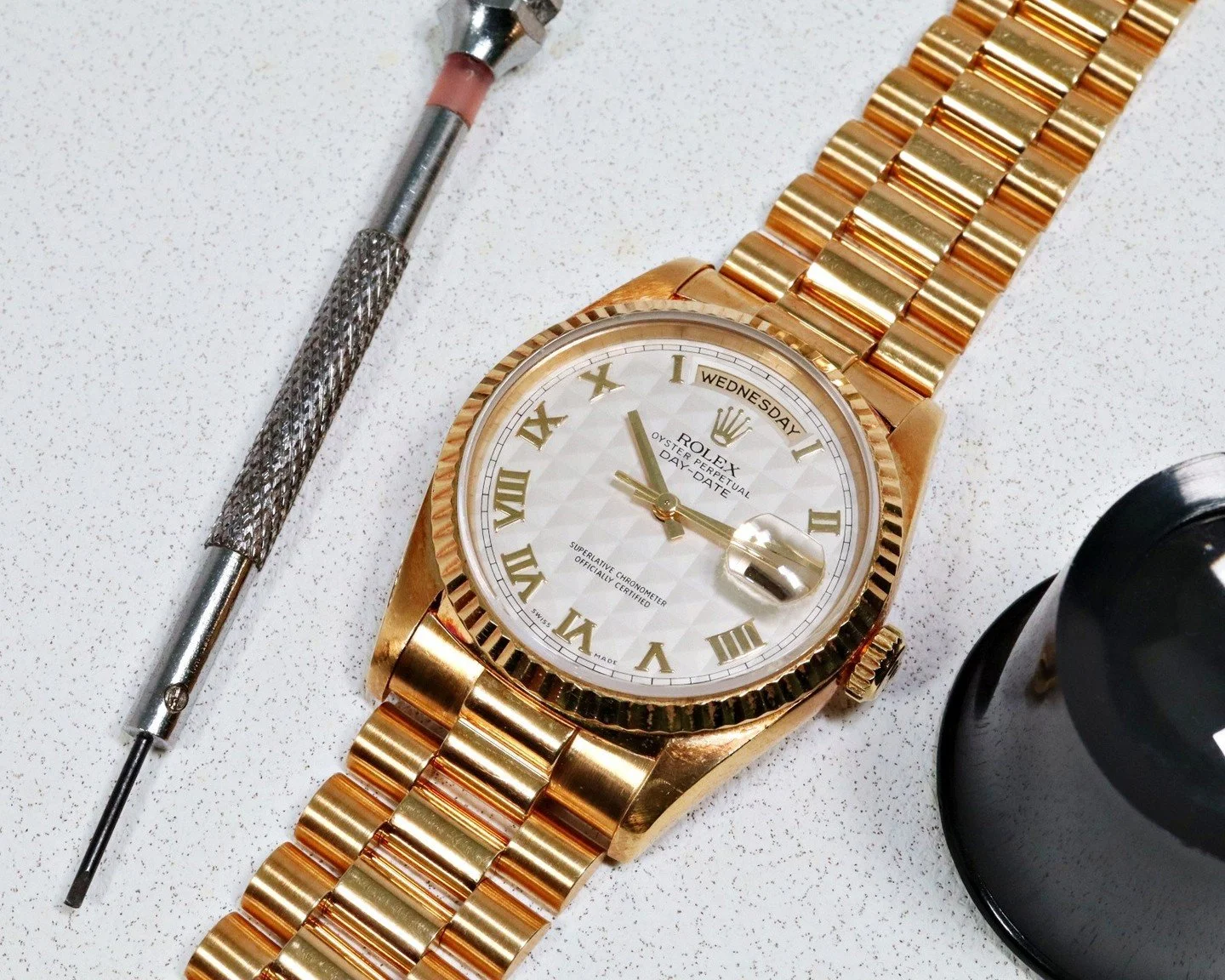 Fitted with a factory white pyramid dial featuring three dimensional triangular motifs, this 18238 features applied gold Roman numerals with matching yellow gold hands and a fluted bezel and comes accompanied with both the original papers and origina