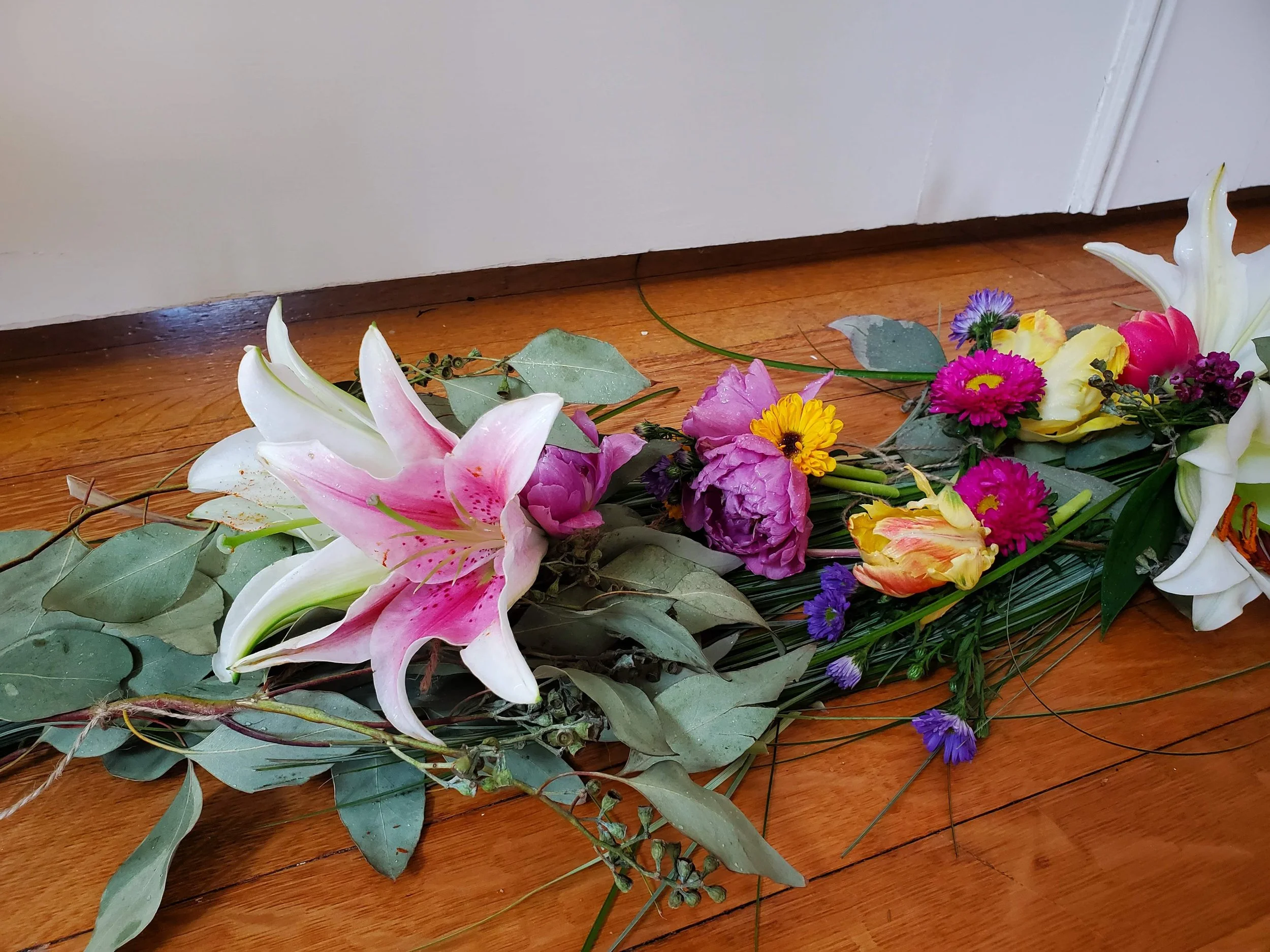 All Natural Floating Flower Garland - $95 to $200. Beautiful memorial tribute when remembering a loved one with lilies, roses, and a variety of radiant flowers as desired.