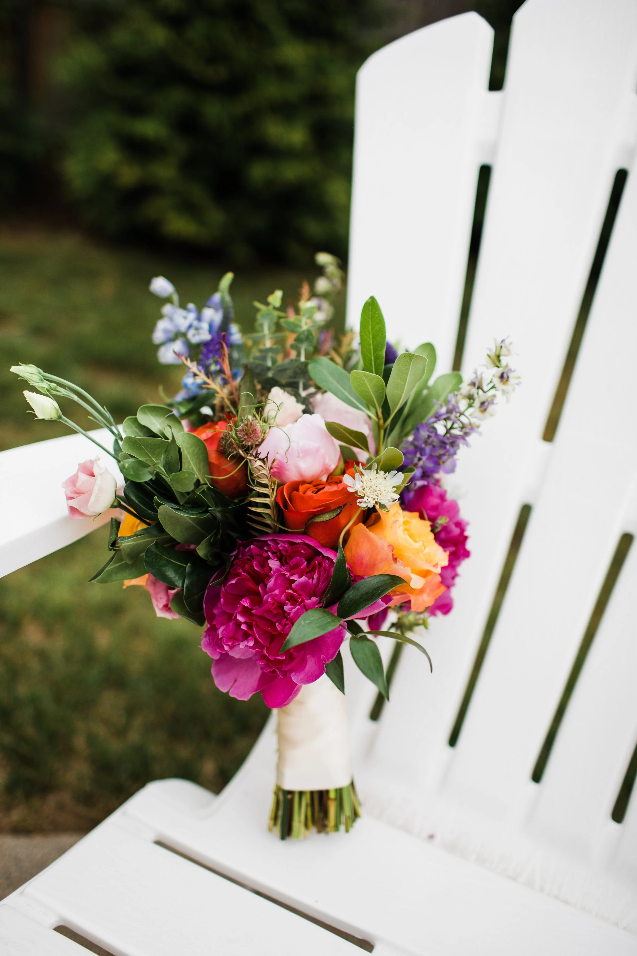 pink peony, orange rose, blue delphinium, seasonal wedding flowers