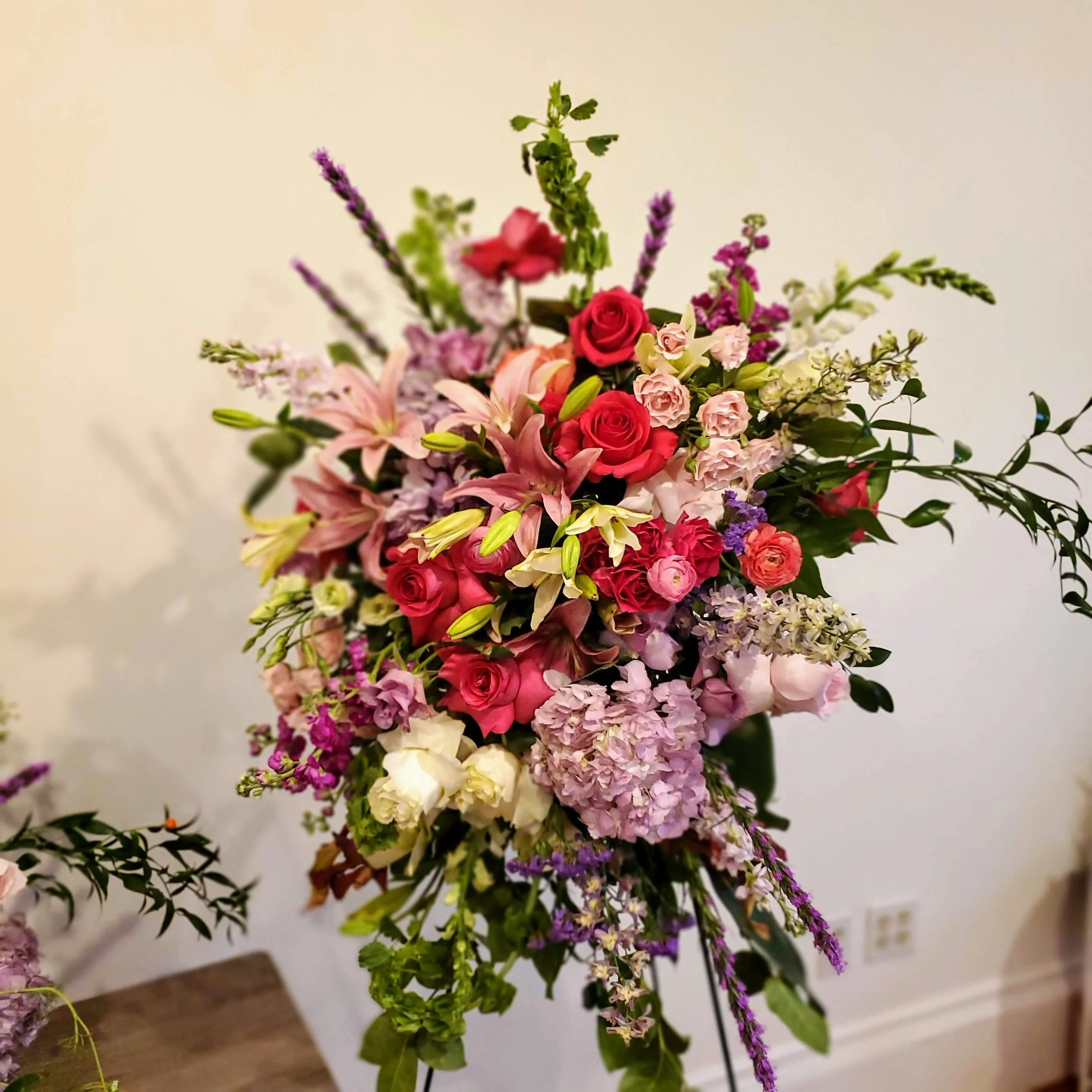 Luxurious Standing Spray with Ruffled Roses and Lilies. - $250 to $450