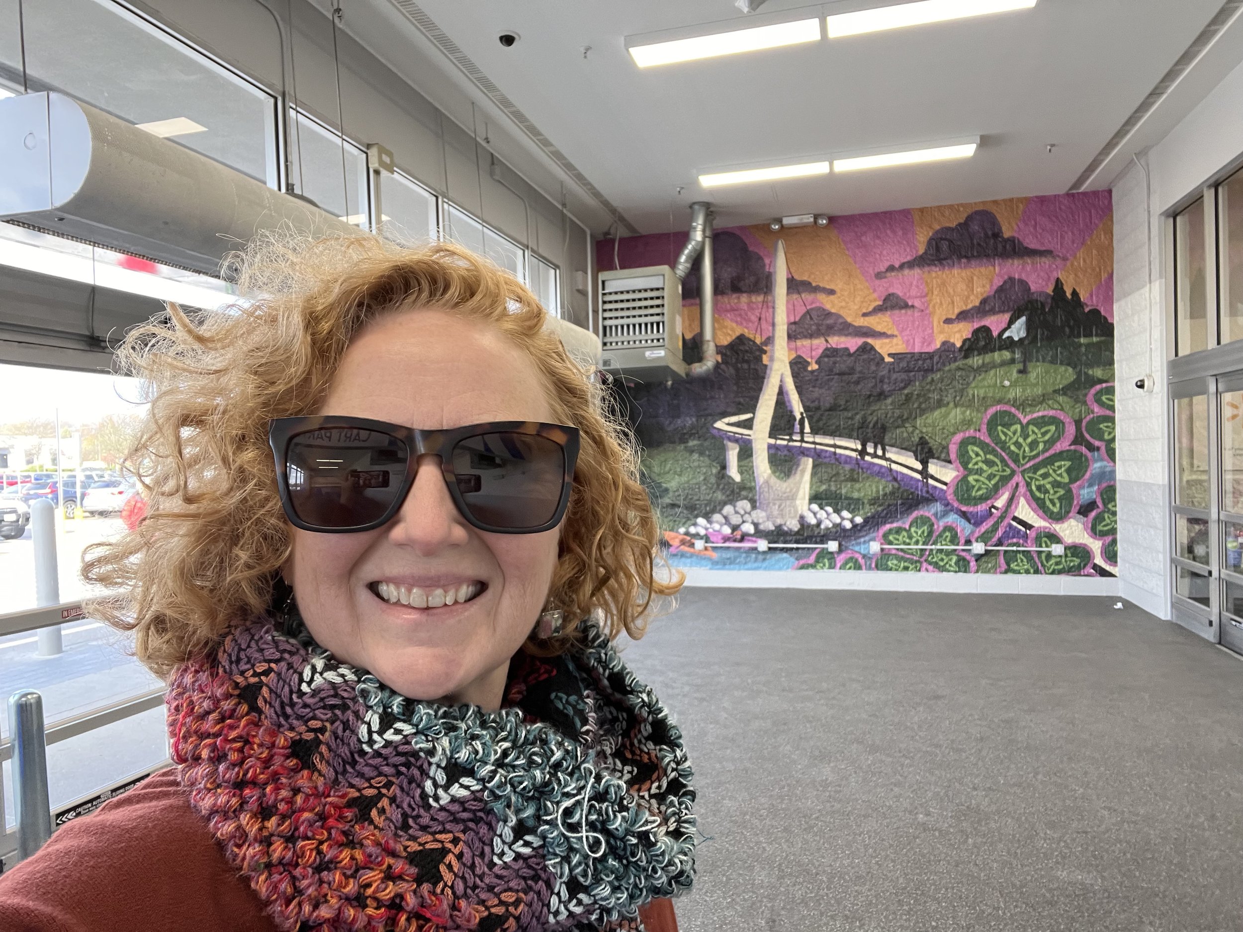 Artist infront of a mural in Dublin, Ohio Walmart