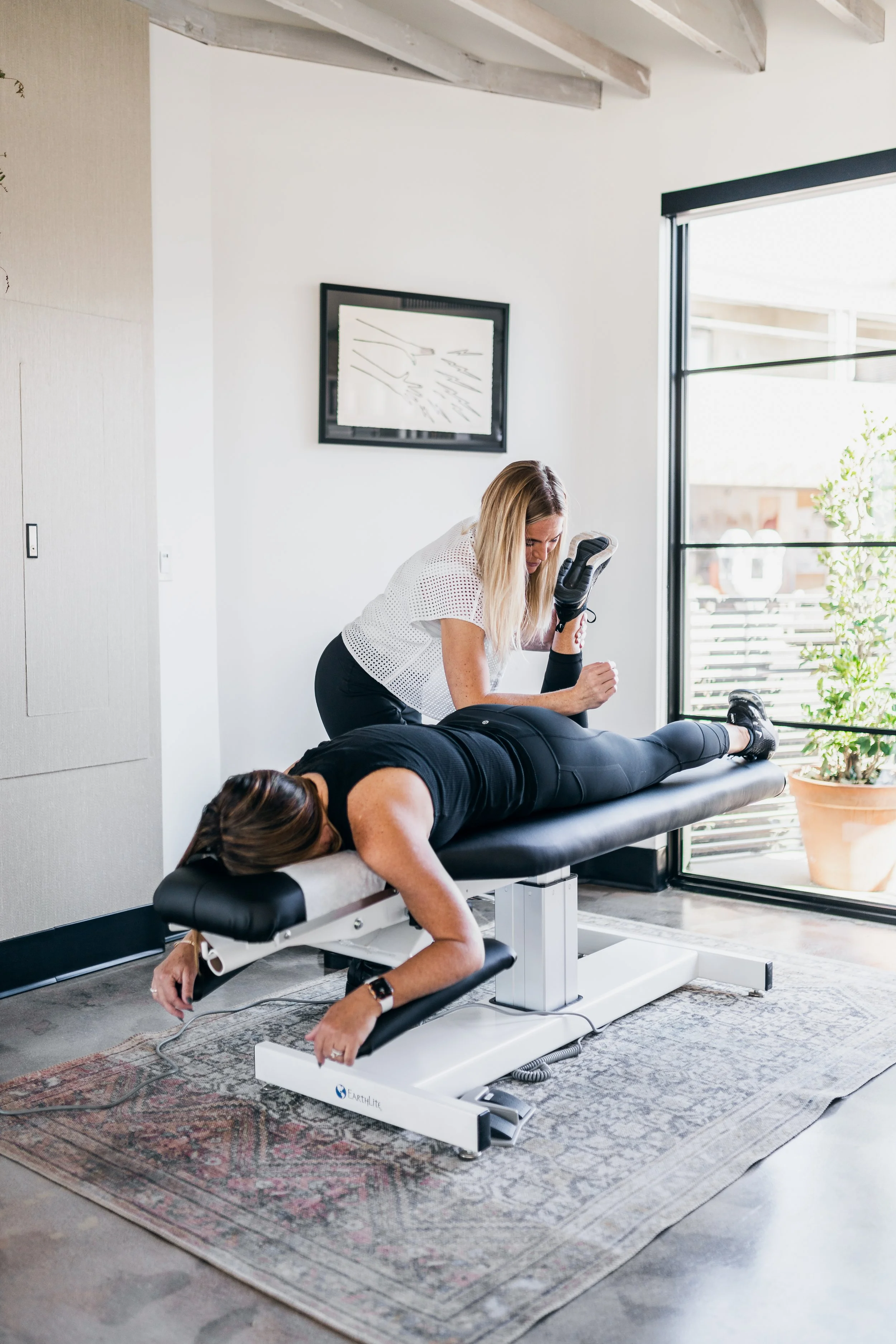 Dr. Julie Stefanski treating a patient's lower back for sciatica pain at Wholistic Abode in Newport Beach