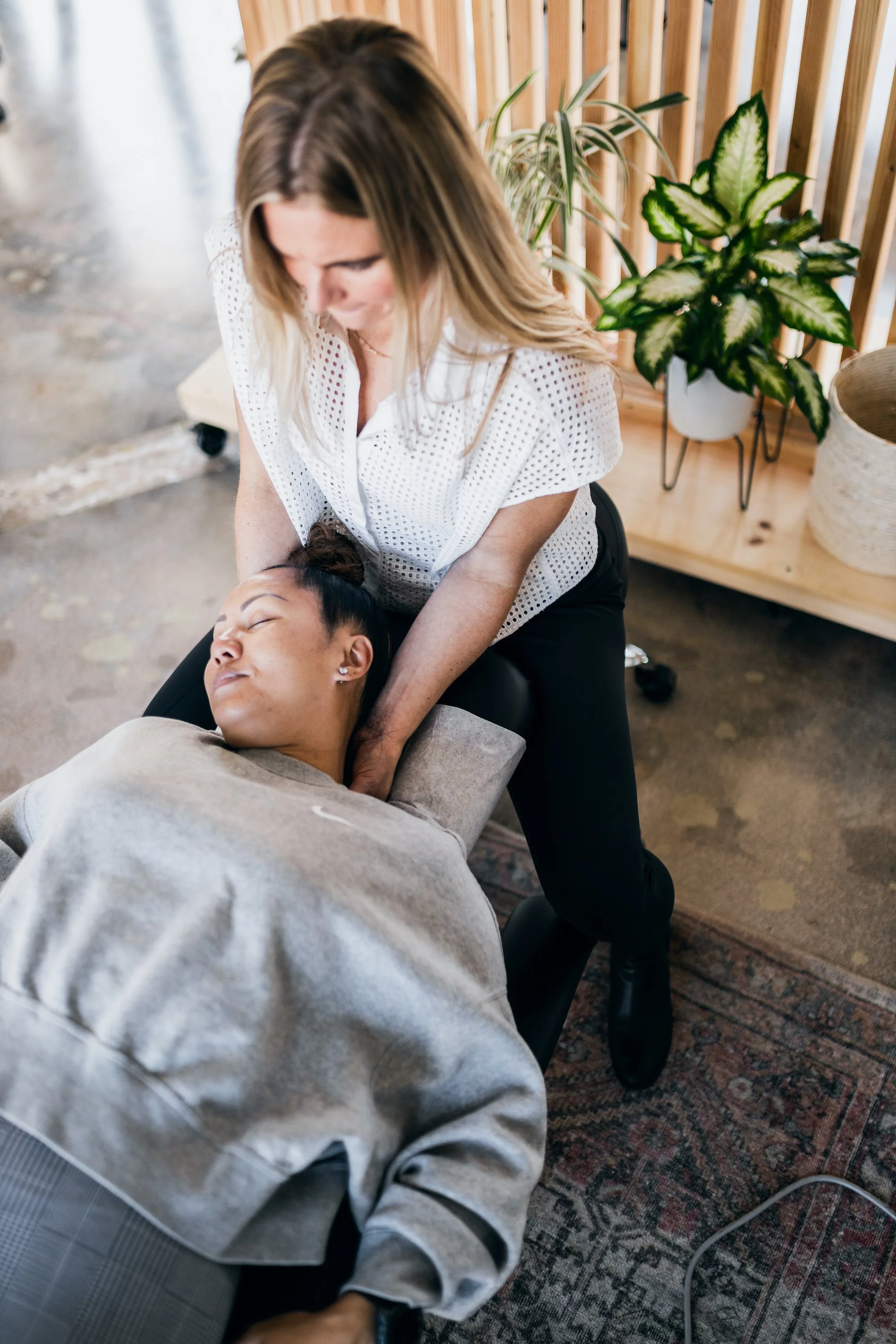 Dr. Julie Stefanski treating a patient's neck for migraine relief at Wholistic Abode in Newport Beach