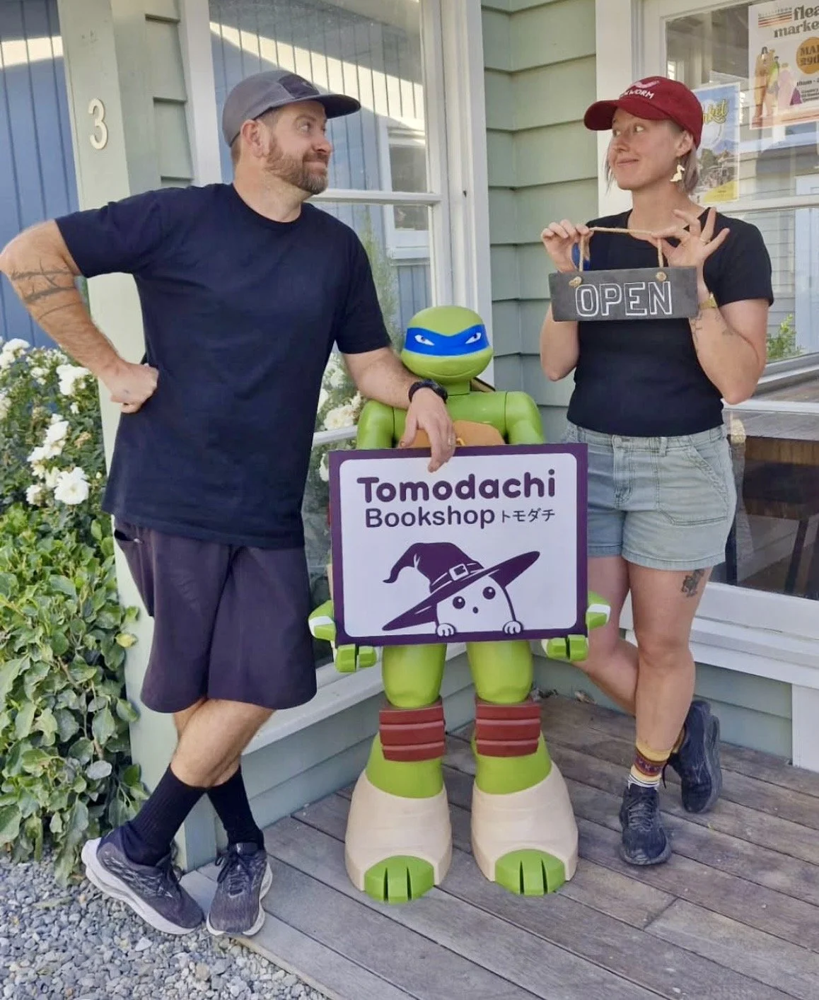Kody and Bee, the owners of Tomodachi Book Shop standing outside their shop at Country Lane Retail Village in Queesntown.