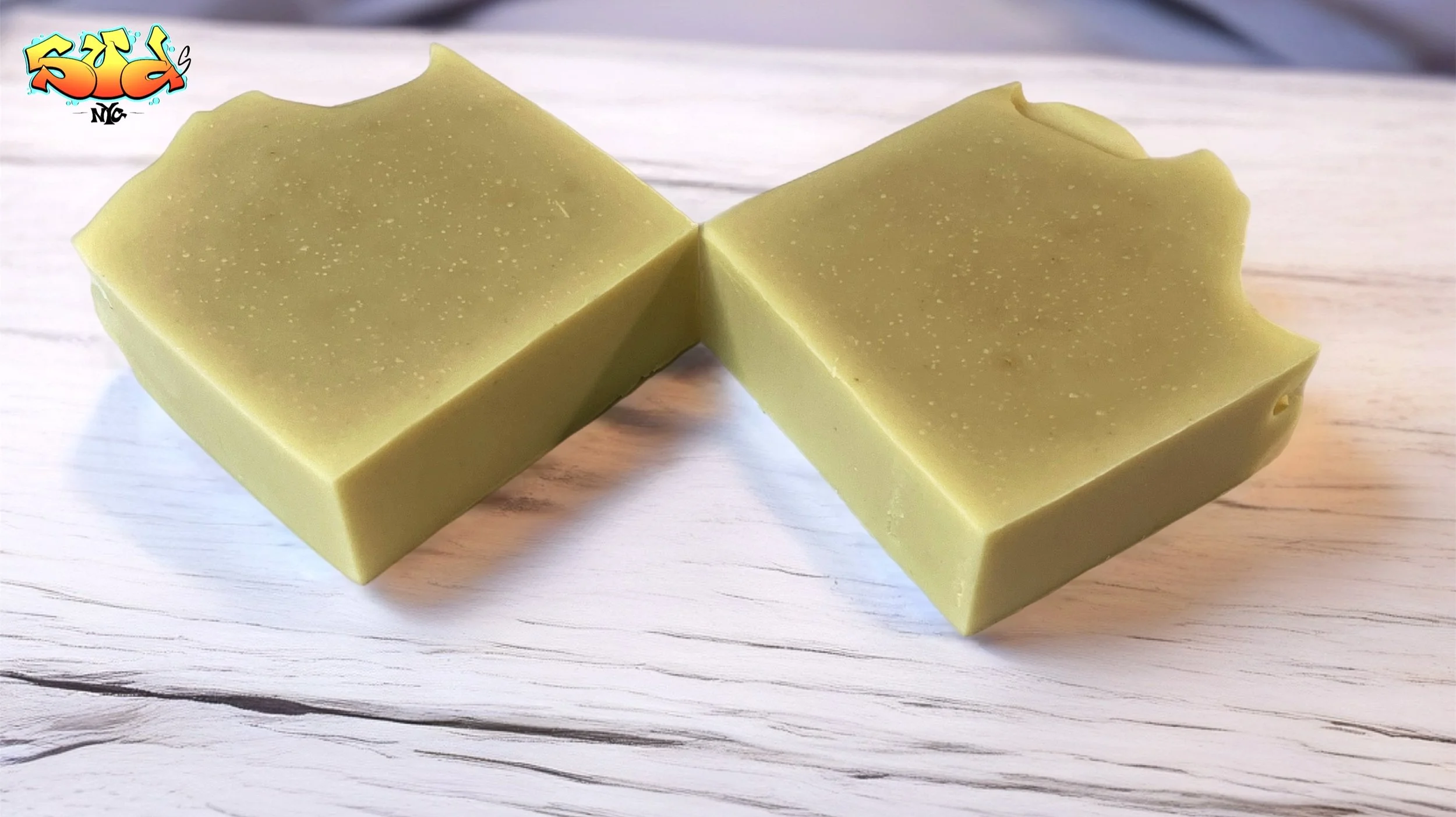 Two Golden Equinox handcrafted carrot powder soap bars displayed on a light marble surface, showcasing their smooth golden finish and clean-cut edges.