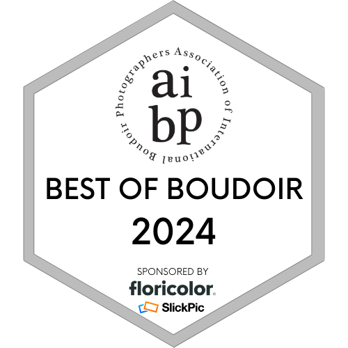An award badge from the International Boudoir Photographers Association, titled 'Best of Boudoir 2024,' sponsored by Floricolor and SlickPic.