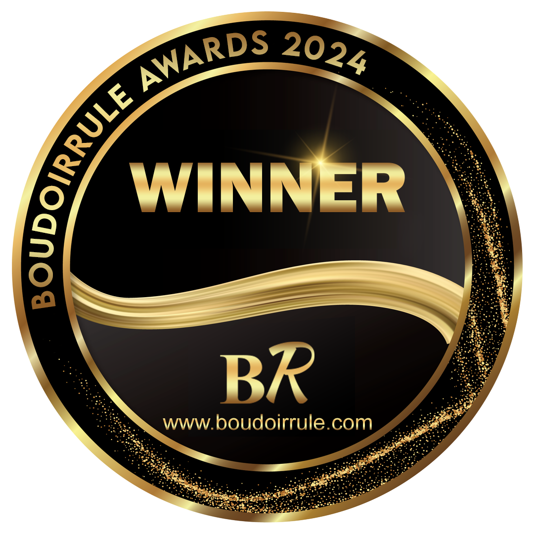 Gold and black circular badge, with the words "BOUDOIR RULE AWARDS 2024" around the top, "WINNER" in large gold letters in the center, and the website "www.boudoirrule.com" at the bottom. Gold glitter accents and a gold ribbon design are present.