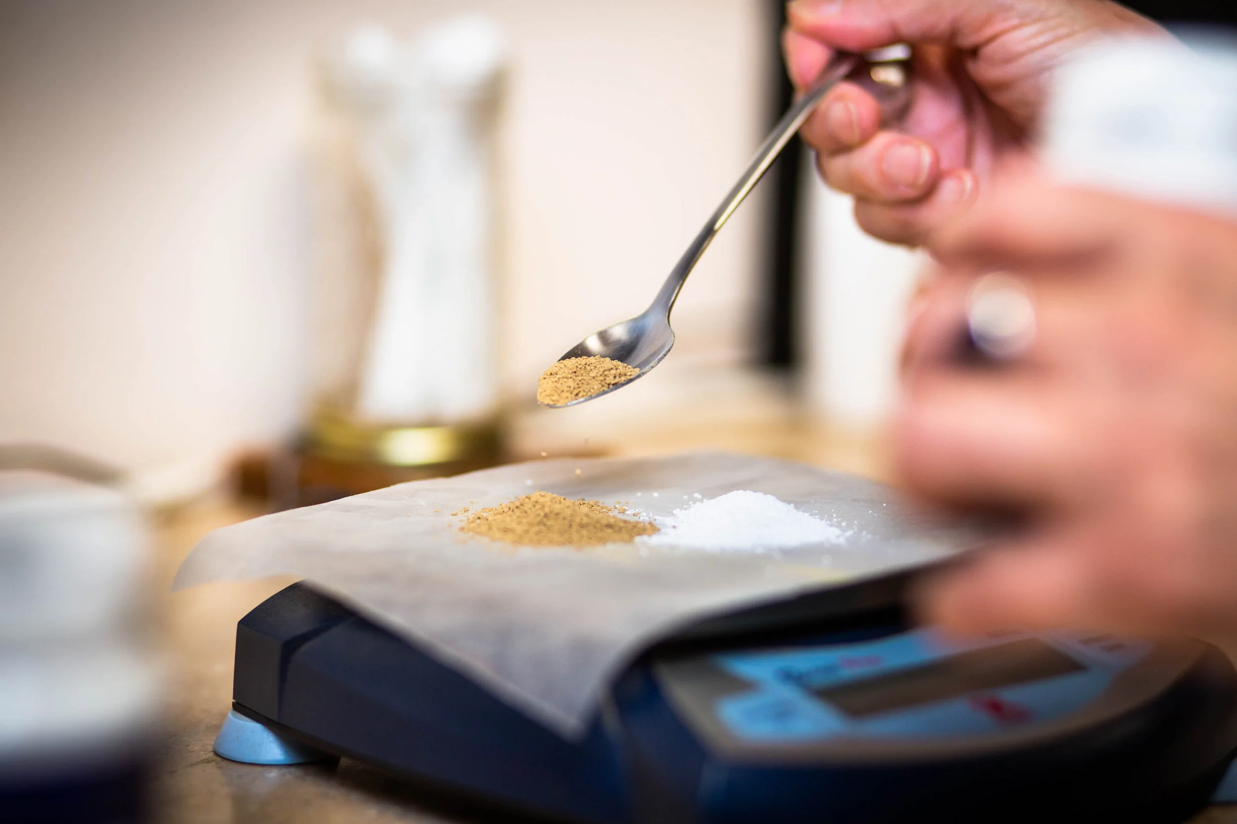 Dr Donna weighing out granular herbs