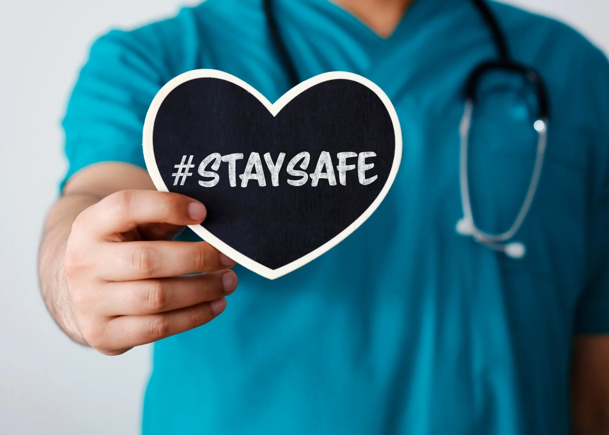 Medical provider with STAY SAFE sign