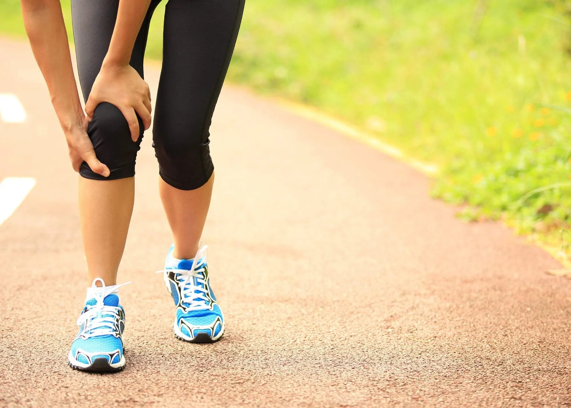Girl hold knee from an injury