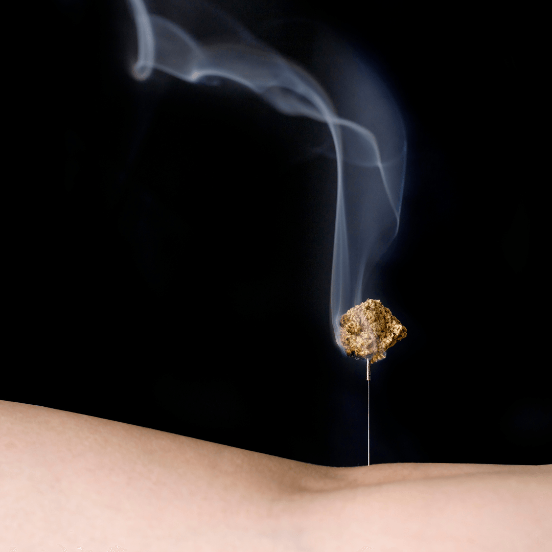 Needle top moxa on the stomach with smoke with a black background