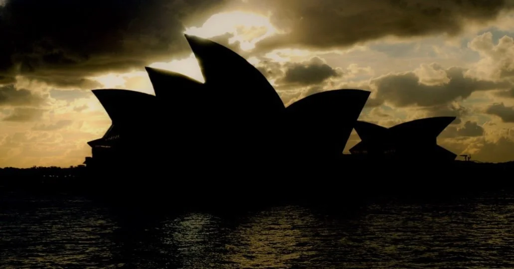 Before the city speaks, the harbour glows.