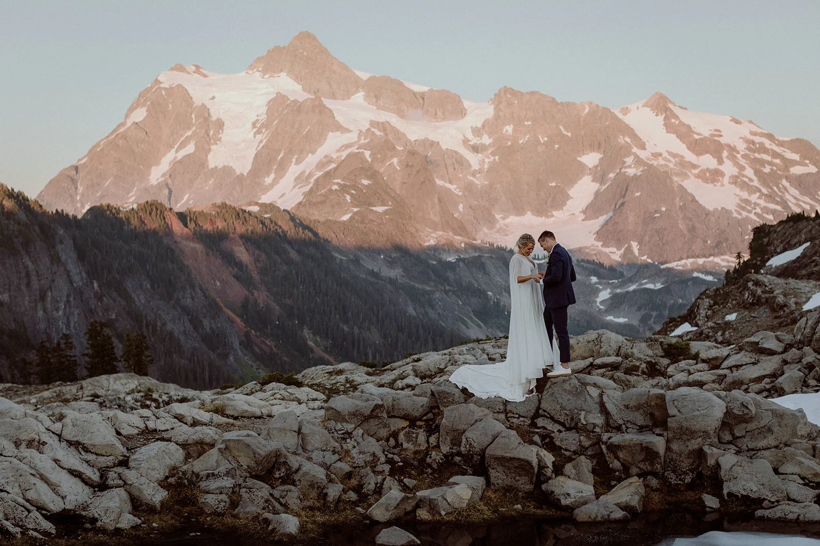 An epic photo of a couple in front of mountain backdrop for their elopement.