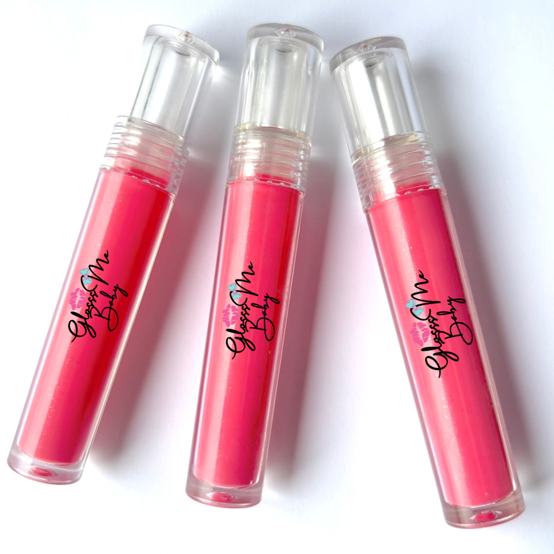 Three lip gloss tubes with pink gloss, labeled 'GlossMe by Baby' with a blue heart and pink lipstick icon, placed on a white surface.