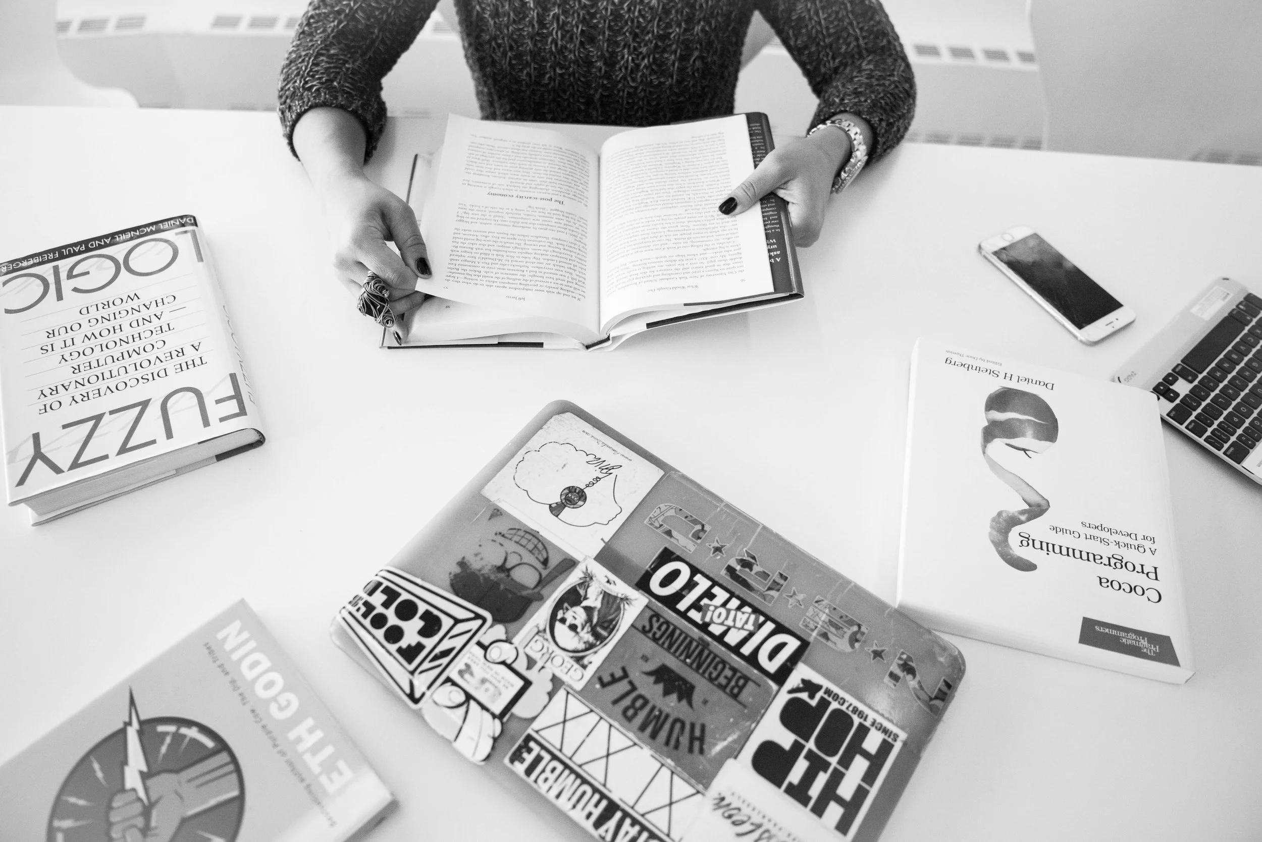 Squarespace designer sitting at a desk with books and laptop