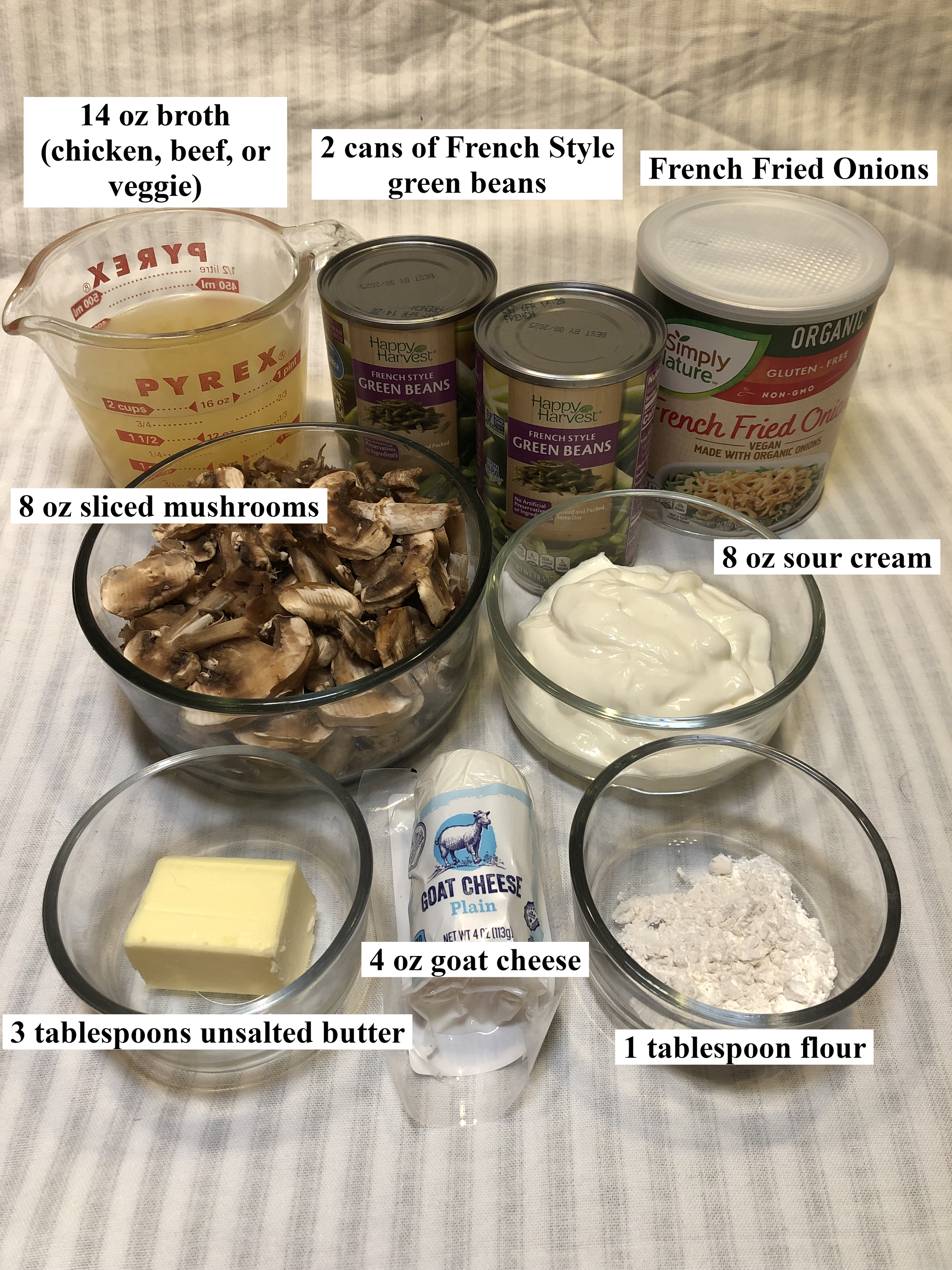 Image shows all of the ingredients needed to make this green bean casserole recipe. Amounts of each ingredient are labeled in black text over the image.