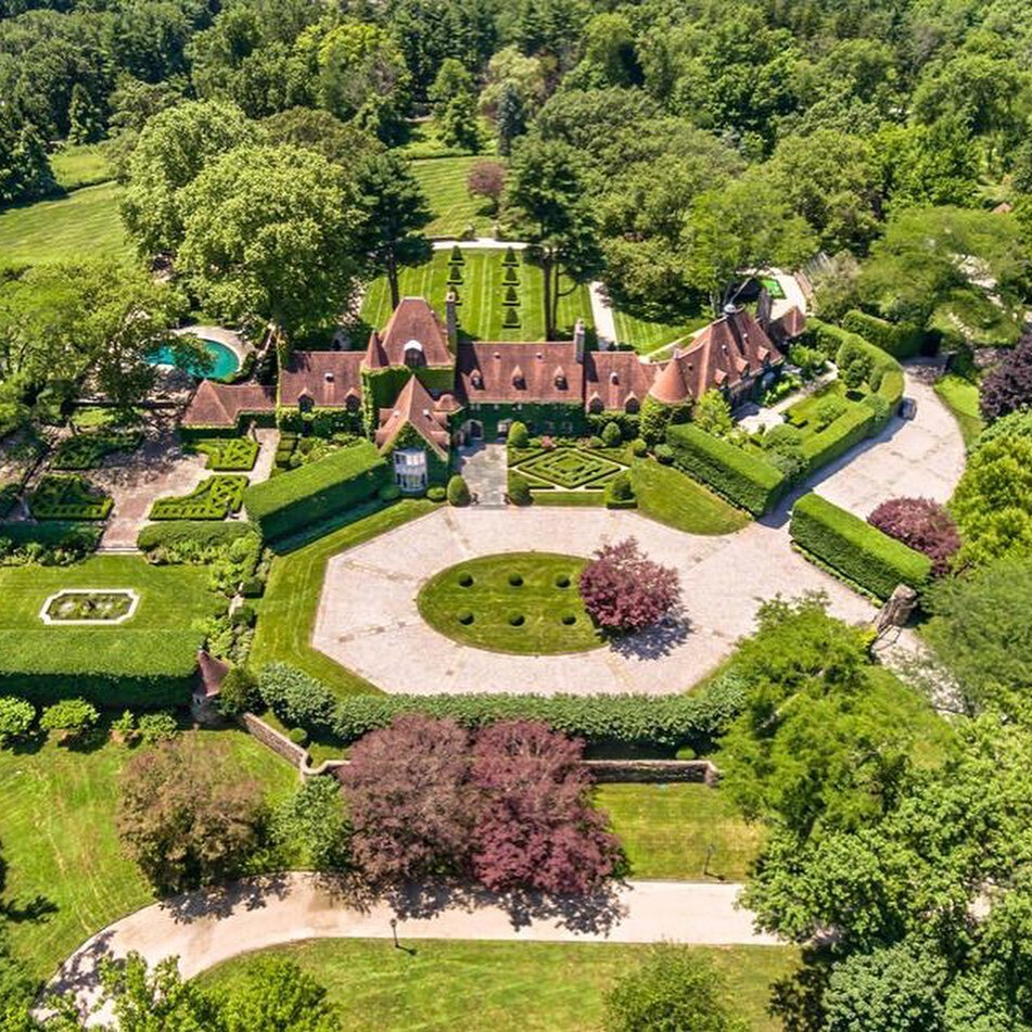 A storied landmark renewed as the home of Tommy and Dee Hilfiger, hallmarked by singular beauty and uncompromising standards, this European-inspired country estate graces 22 private, park-like acres at the summit of Round Hill, the highest point in G