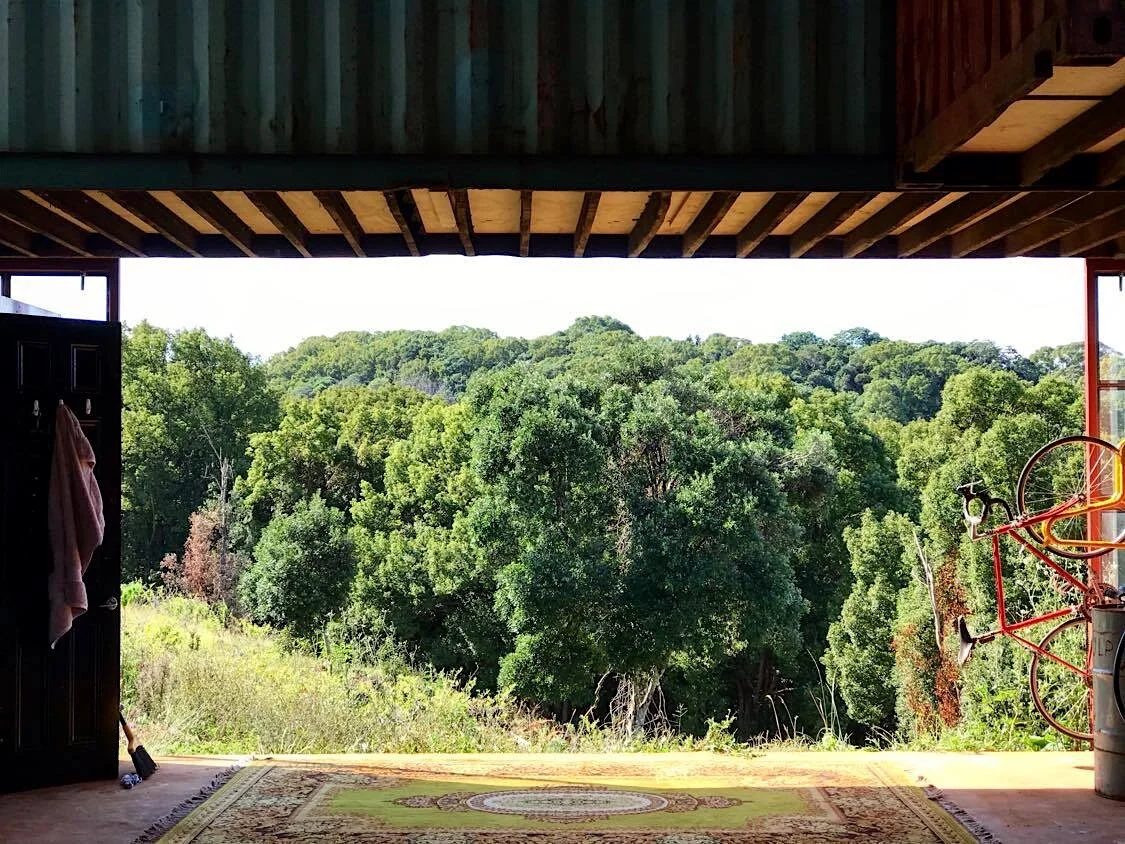 Open garage with wooden ceiling looking out to the Byron hinterland from Cheyenne Farm
