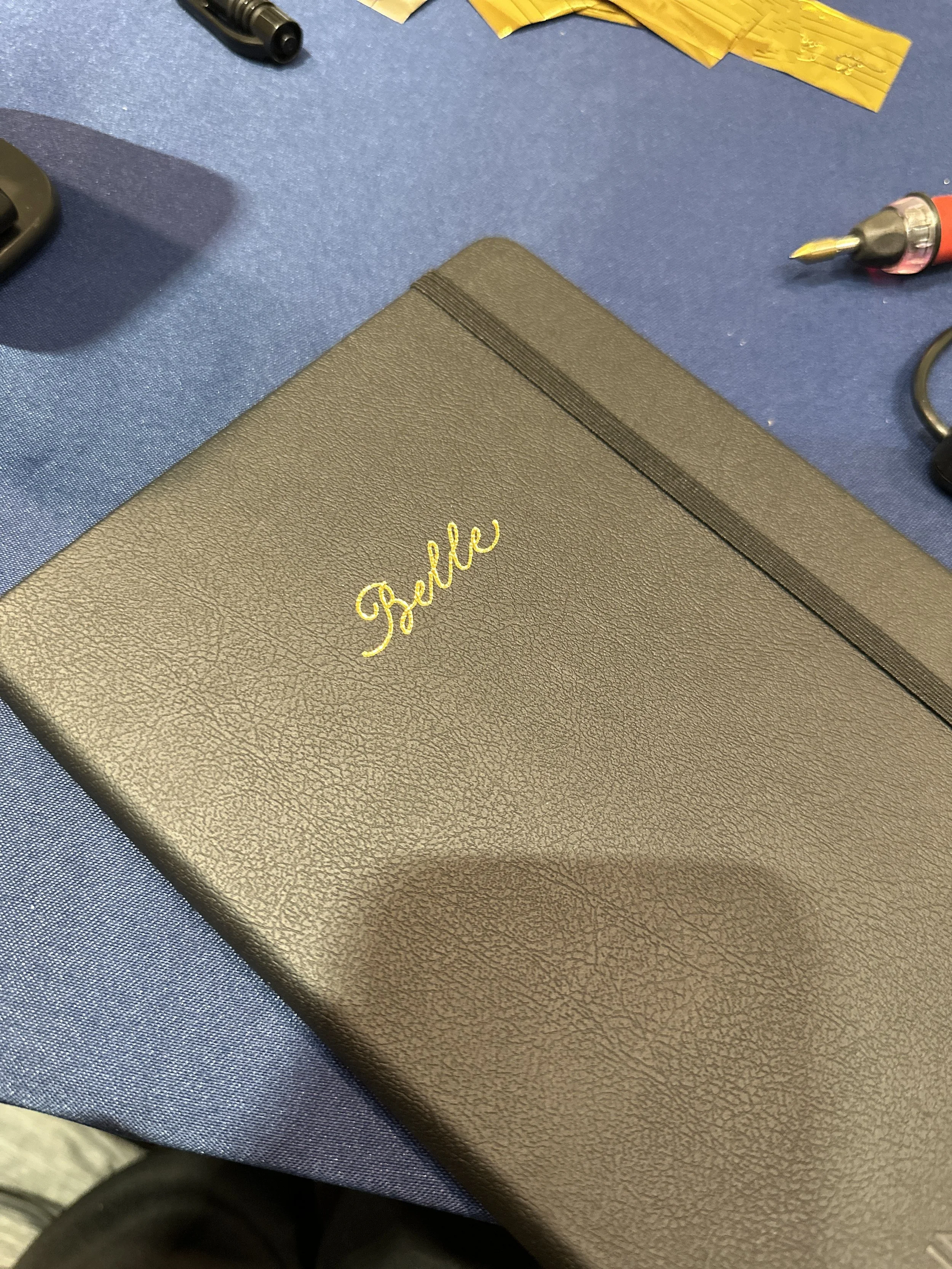 On-site Calligraphy Heat Foiling on notebooks for client event in Hong Kong