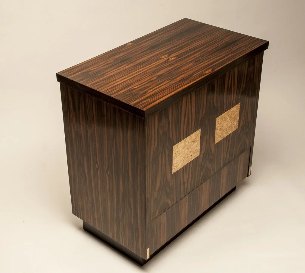 A 1955 Lane Hope Chest with special meaning to the client was reskinned in Macassar Ebony.