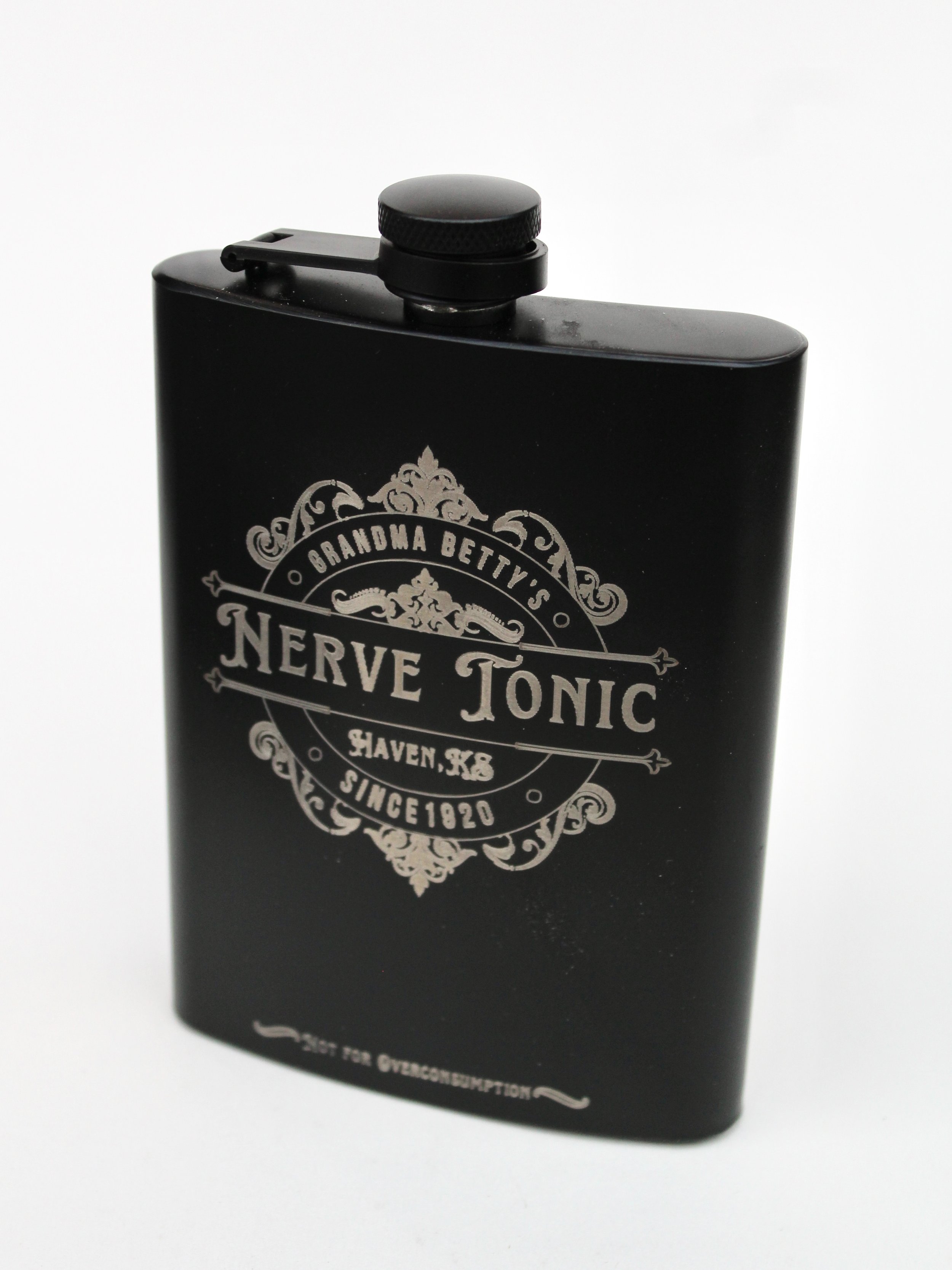 Black beverage flask with Grandma Betty's Nerve Tonic etched in silver on the front.