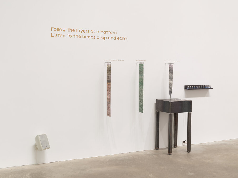  Olivia Whetung,  Strata,  2018-ongoing, 11/0 Miyuki seedbeads, jars, bottles, metal plinth and shelf, audio recording. Installed at the Morris and Helen Belkin Art Gallery, University of British Columbia. Photo: Rachel Topham Photography. 