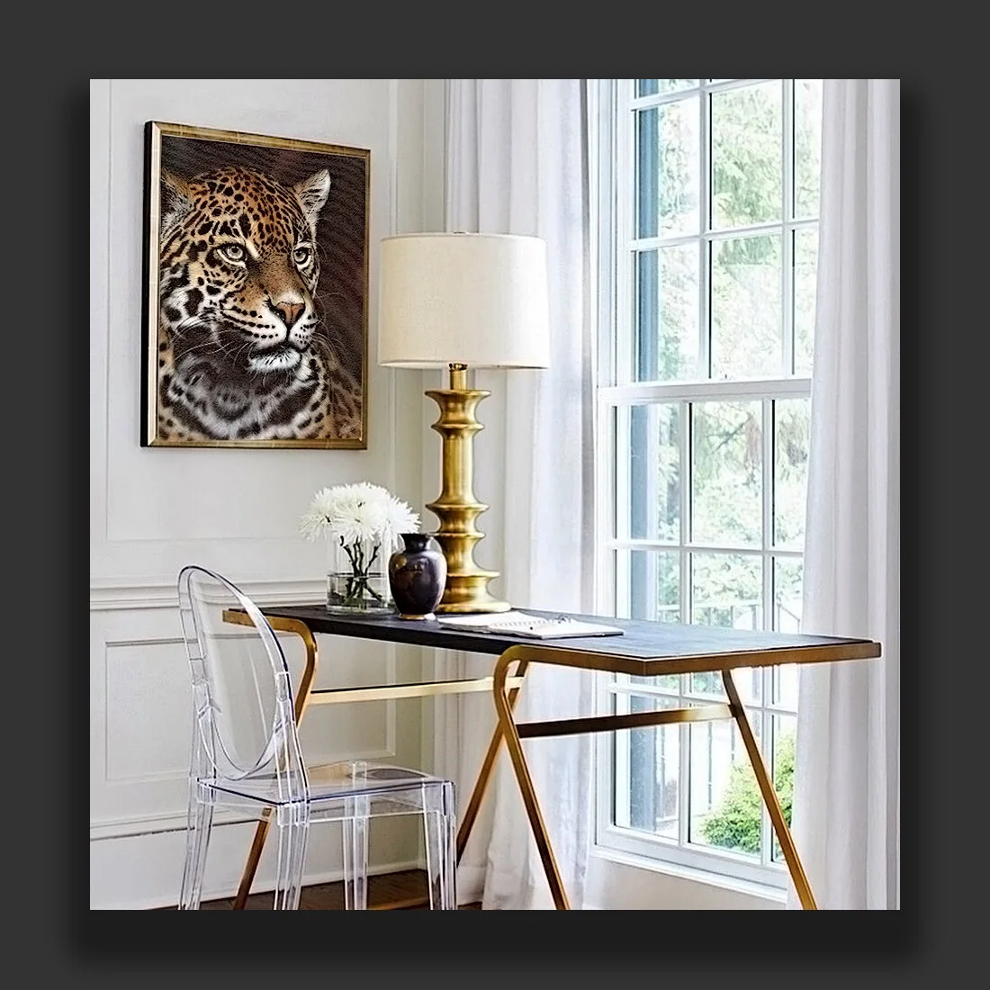 A luxury home office with leopard wall art above a desk, styled with brass accents, white curtains, and refined wildlife artwork by Clint Eagar.