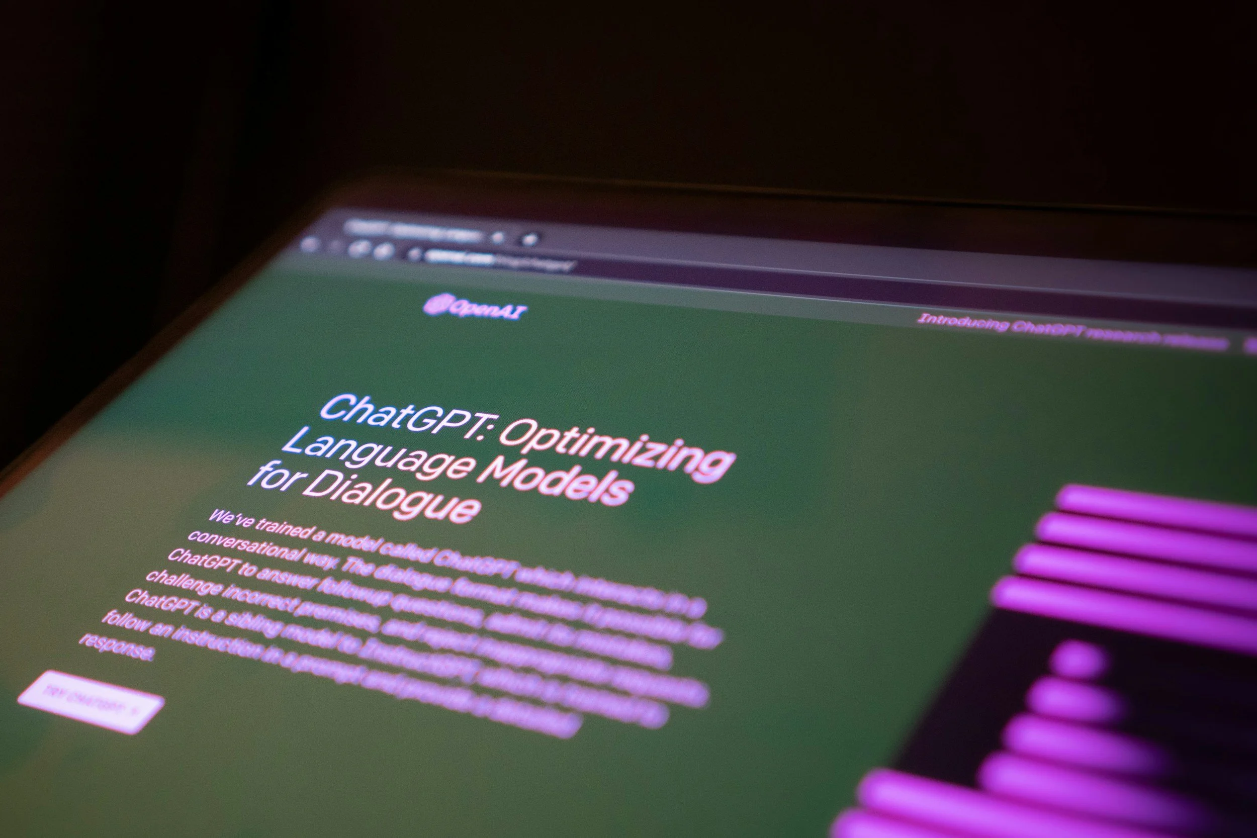A computer screen displaying information about ChatGPT, including the title 'ChatGPT: Optimizing Language Models for Dialogue' in pink text.
