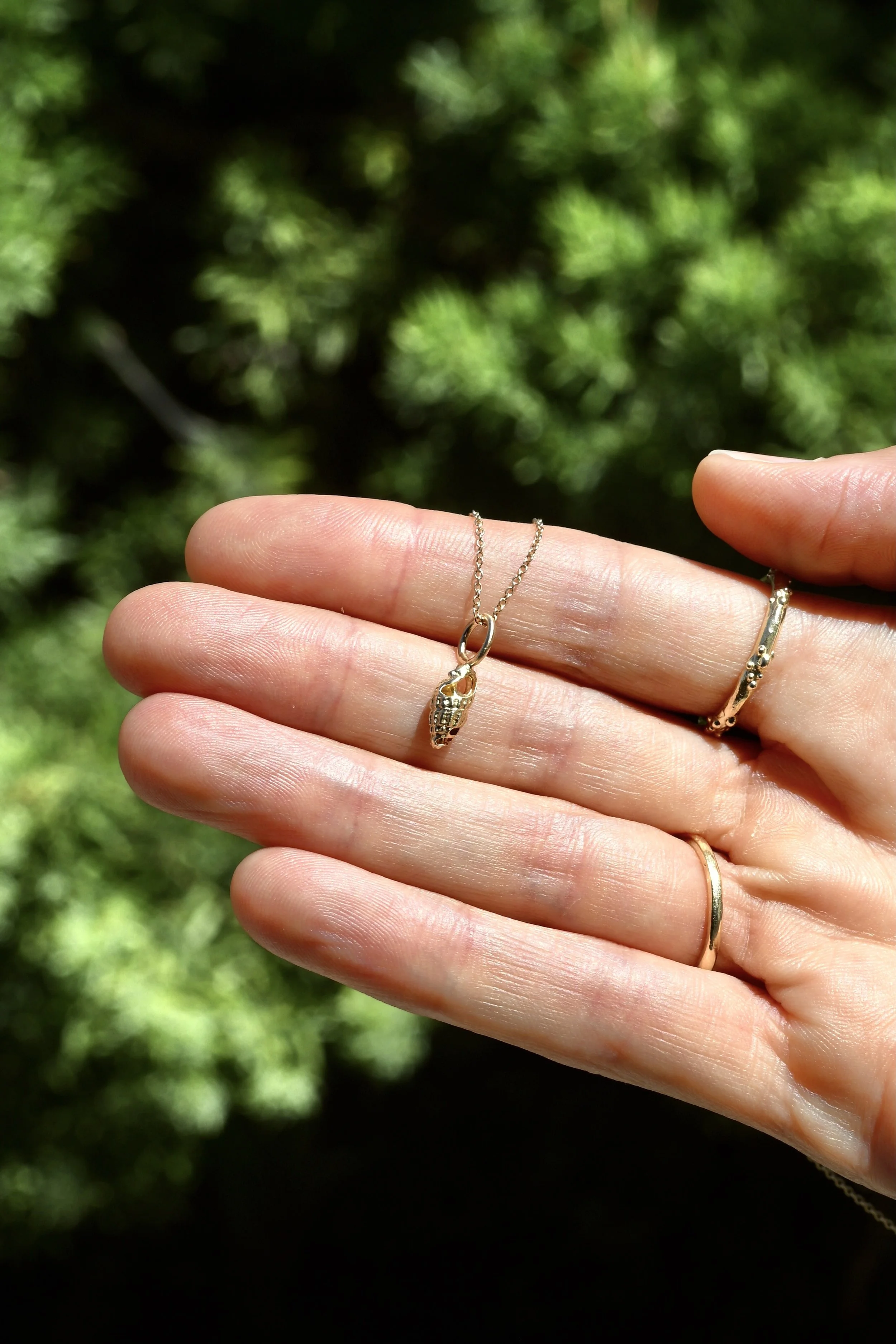 Petite sea snail charm back.JPG