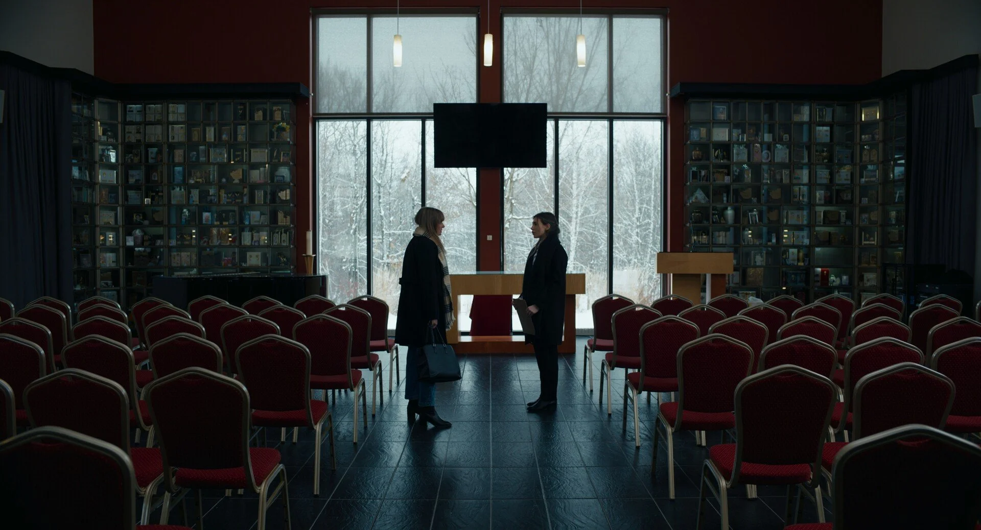 two women looking at eachother in a funeral home